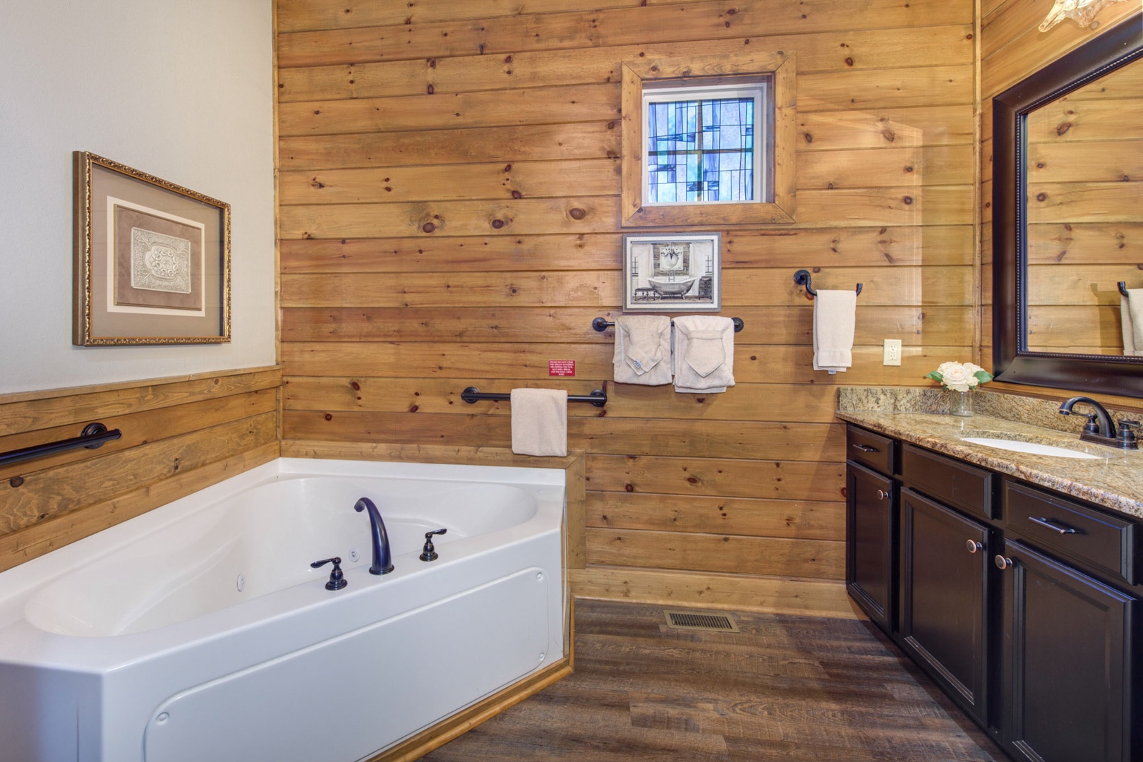 This ensuite bath boasts a large vanity, shower, & luxurious soaking tub