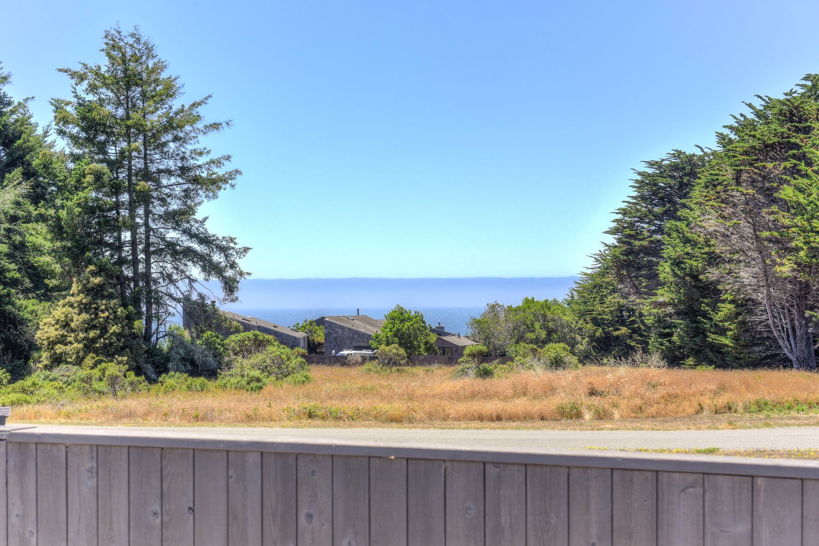 Deck with BBQ, seating, hot tub, and ocean views