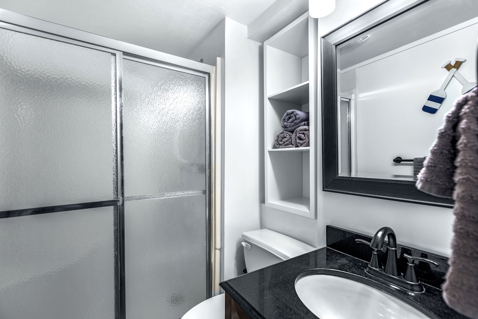 The first-level bathroom includes a single vanity & walk-in shower