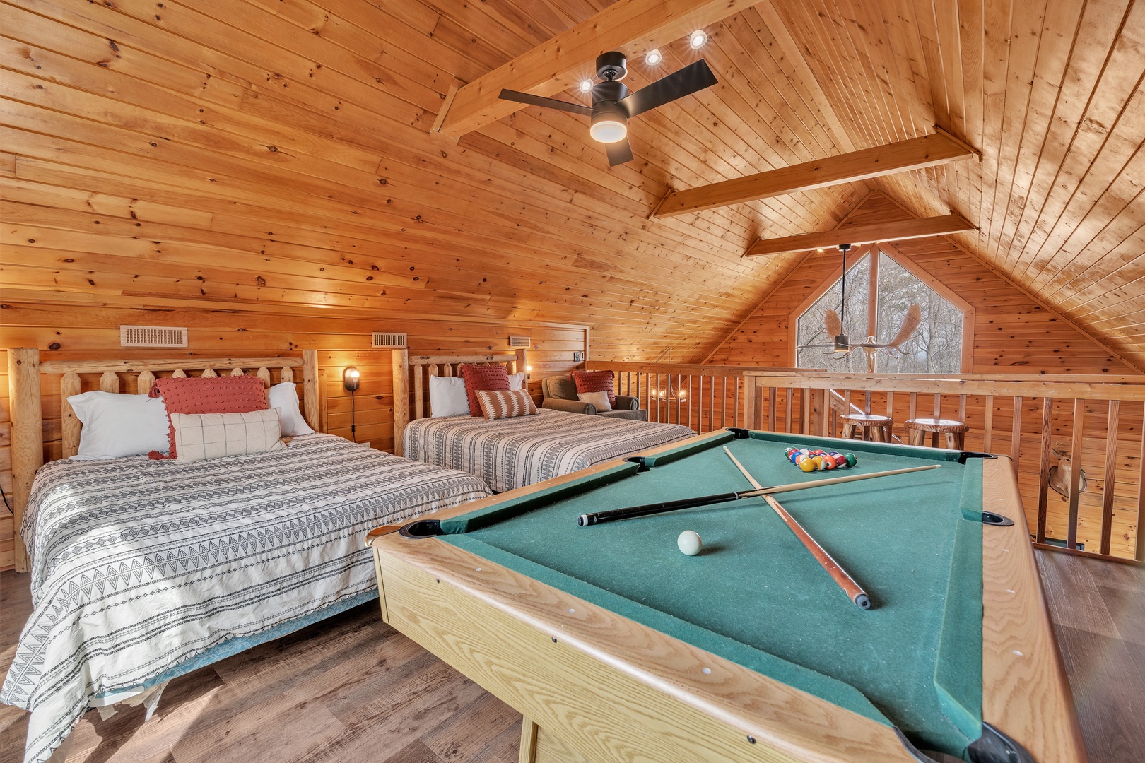 Loft with 2 full beds, pool table, and balcony