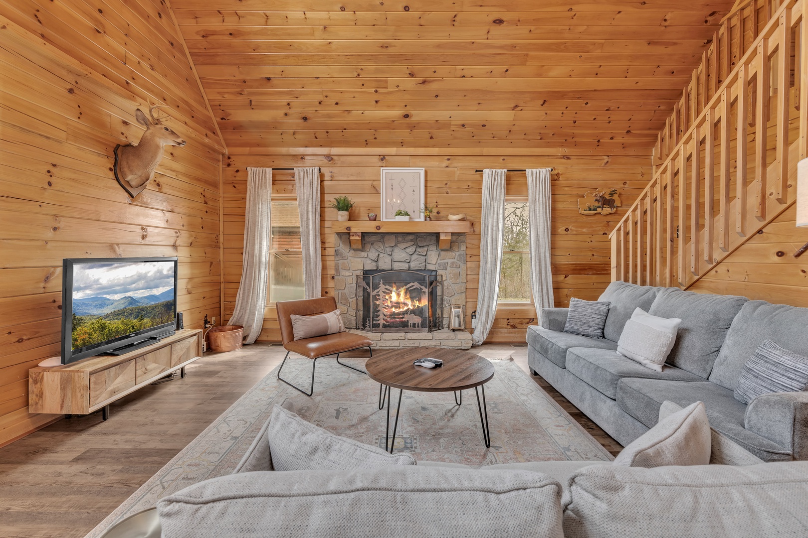 Gather in the spacious living area featuring generous seating, a Smart TV, and a cozy fireplace