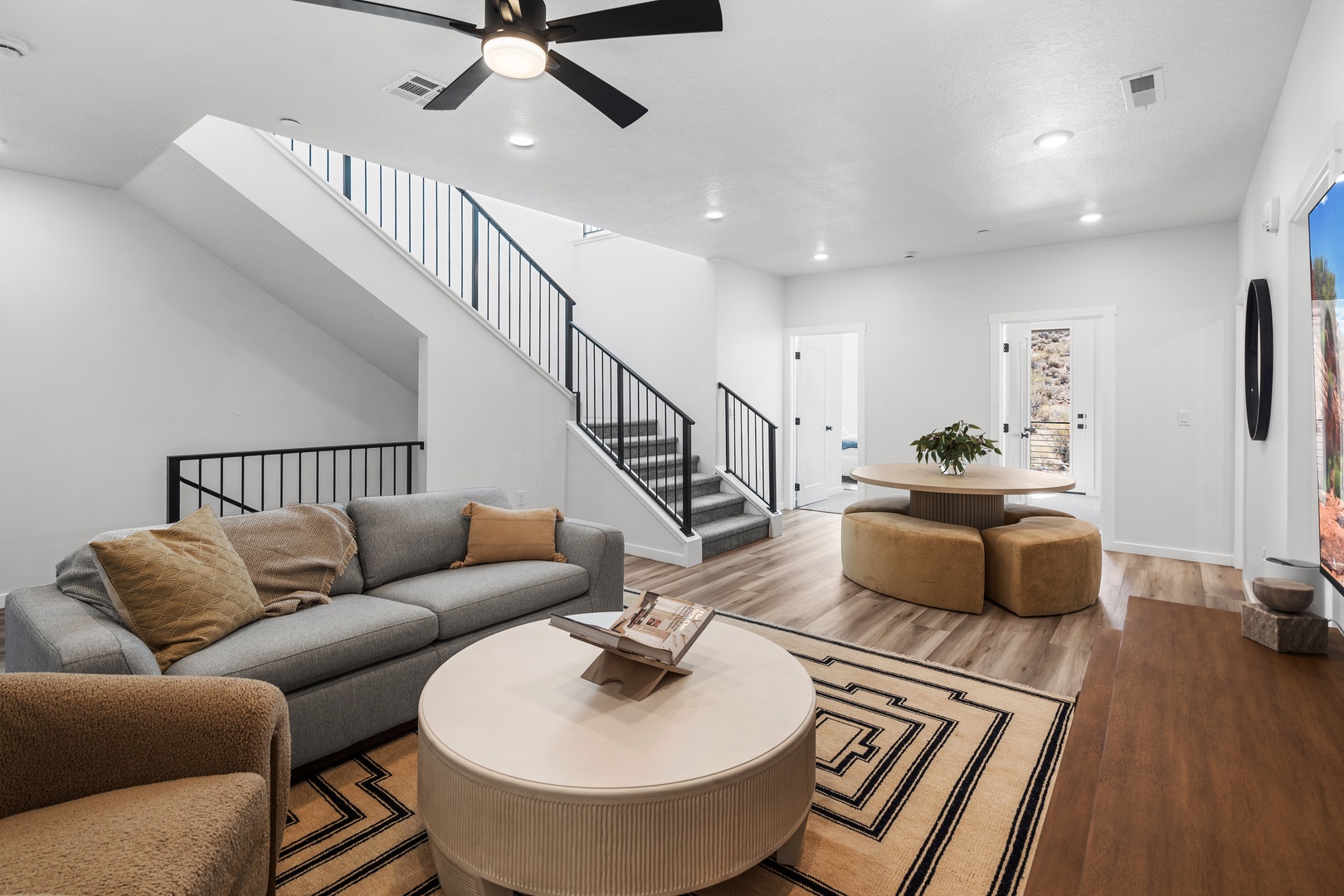 Bottom floor living area with cozy seating and Smart TV