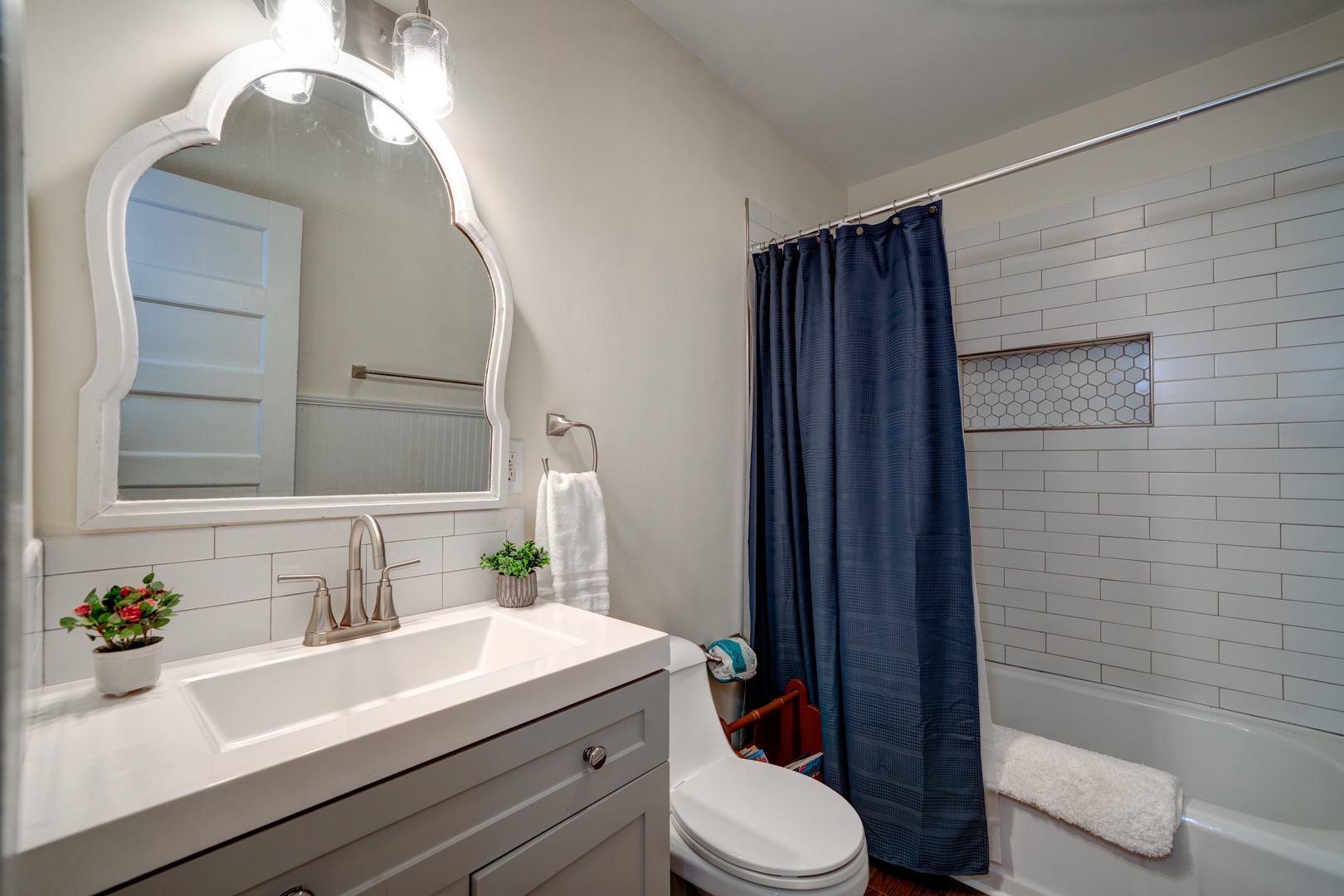 This sophisticated full bath features a single vanity & shower/tub combo