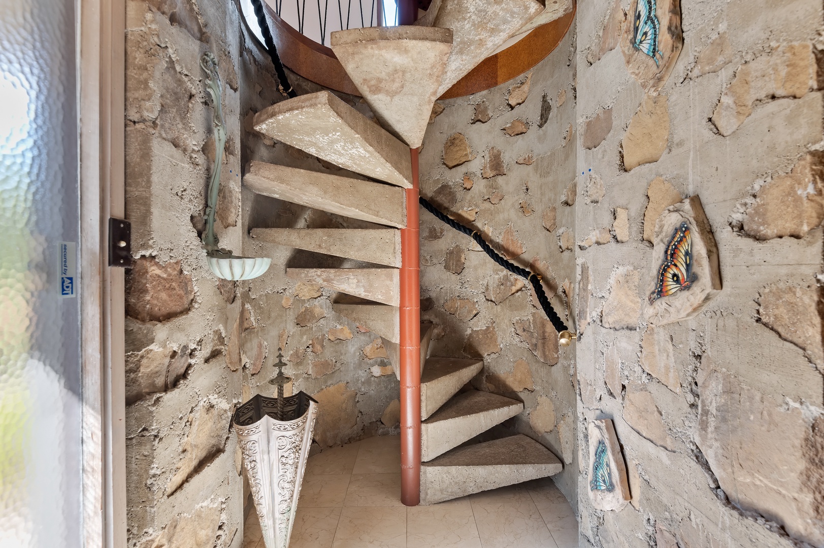Once inside, you will be greeted by an extraordinary stone foyer and spiral staircase