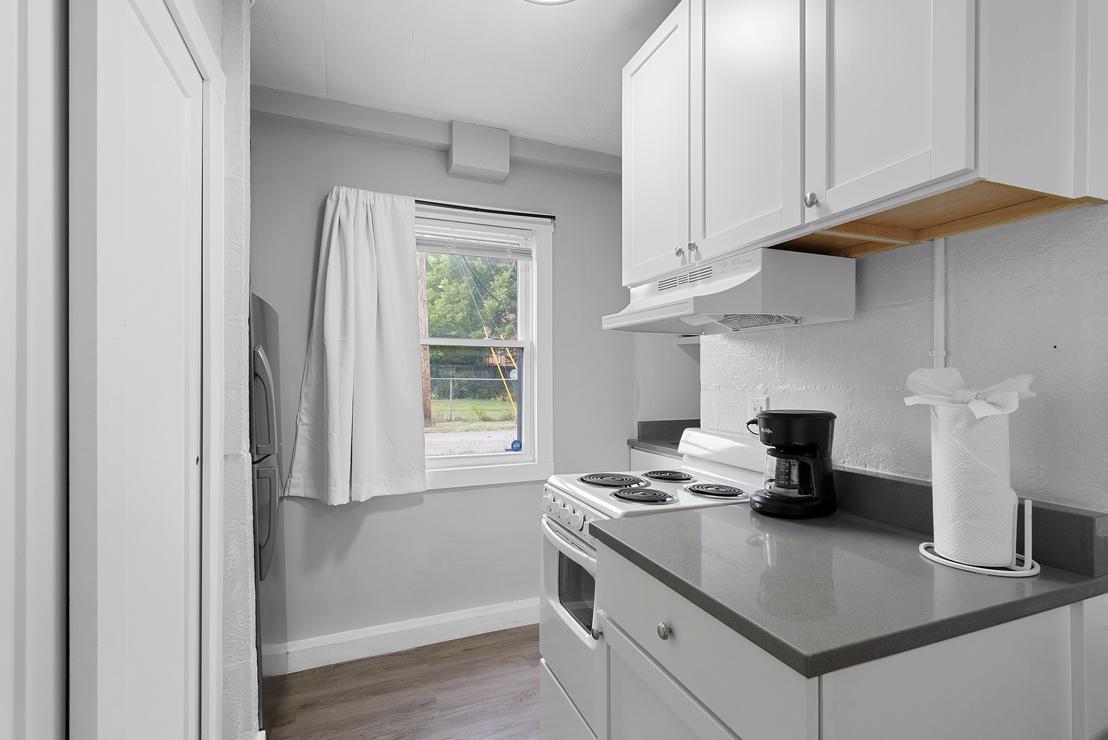 The cozy kitchen offers ample storage space & all the comforts of home