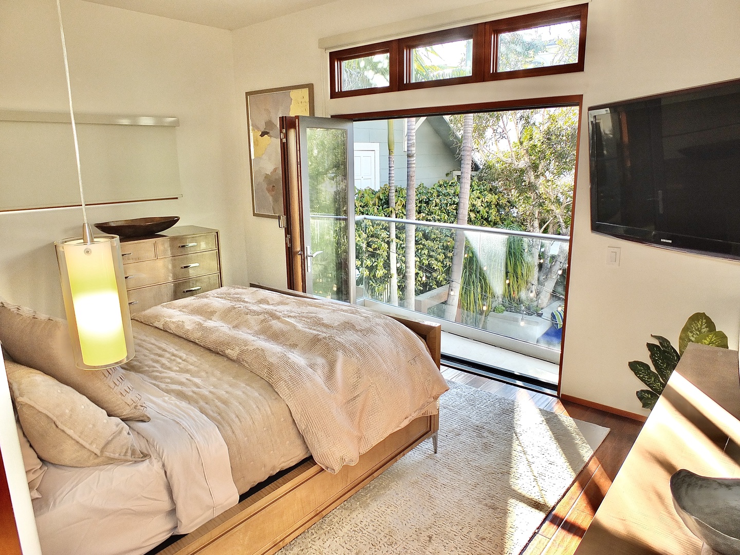 Bedroom 1 with queen bed, Smart TV, balcony, and ensuite