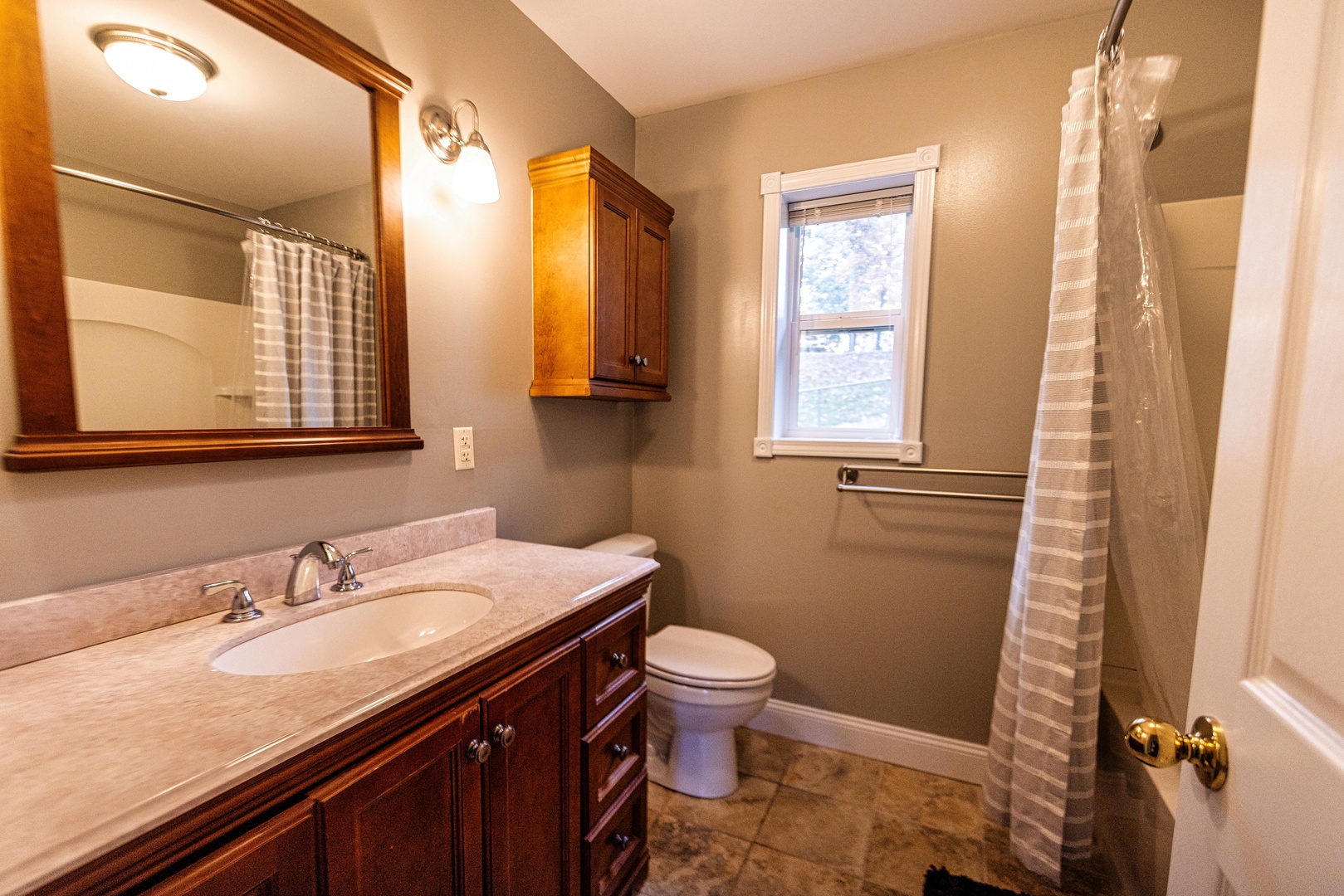 The 1st floor ensuite bath offers a single vanity & shower/tub combo