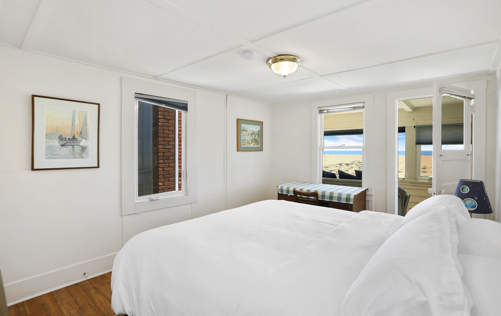 Bedroom #1 with king bed and a small enclosed patio overlooking the beach