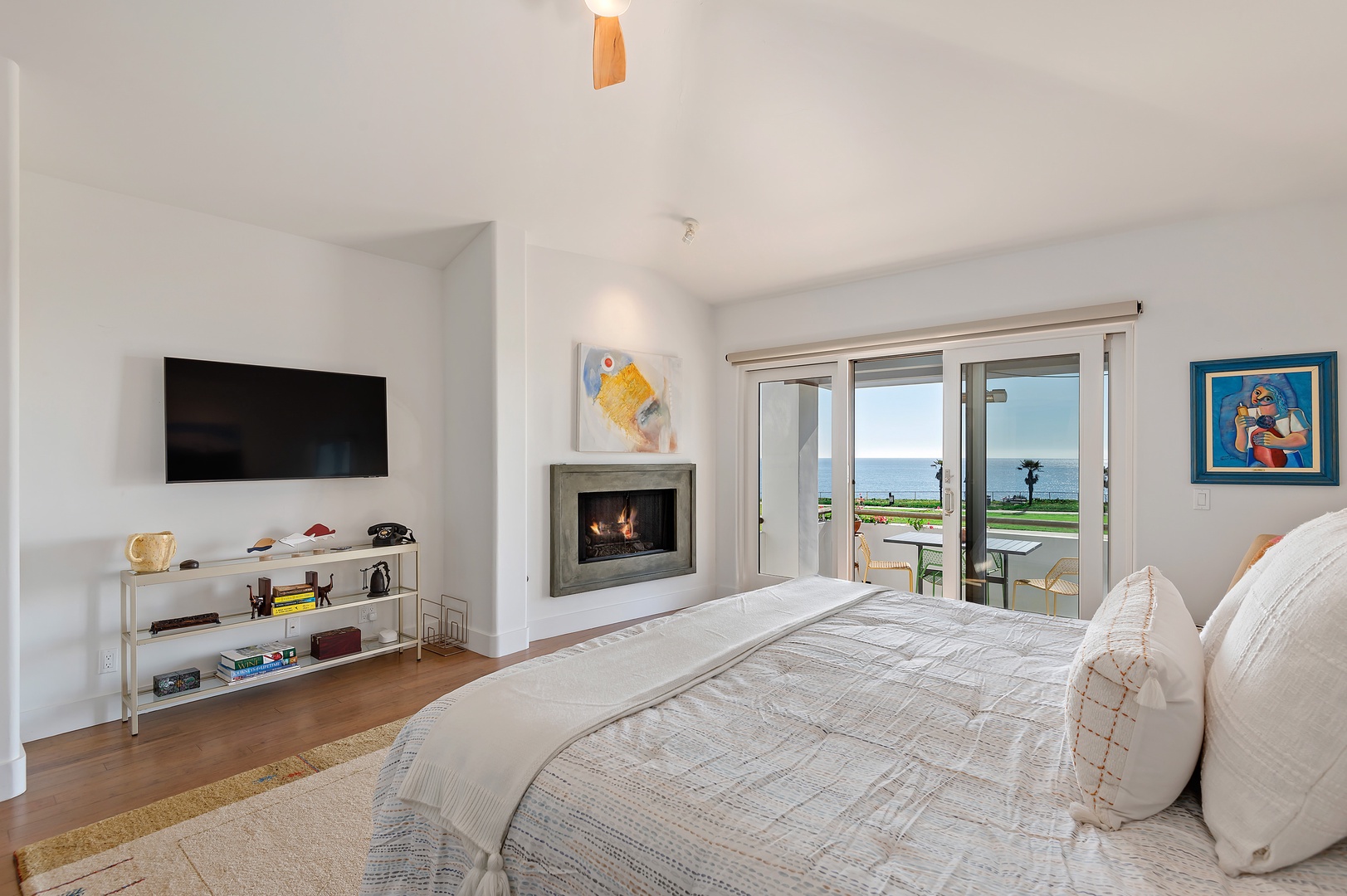 Master bedroom with King bed, Smart TV, fireplace, en suite, and balcony