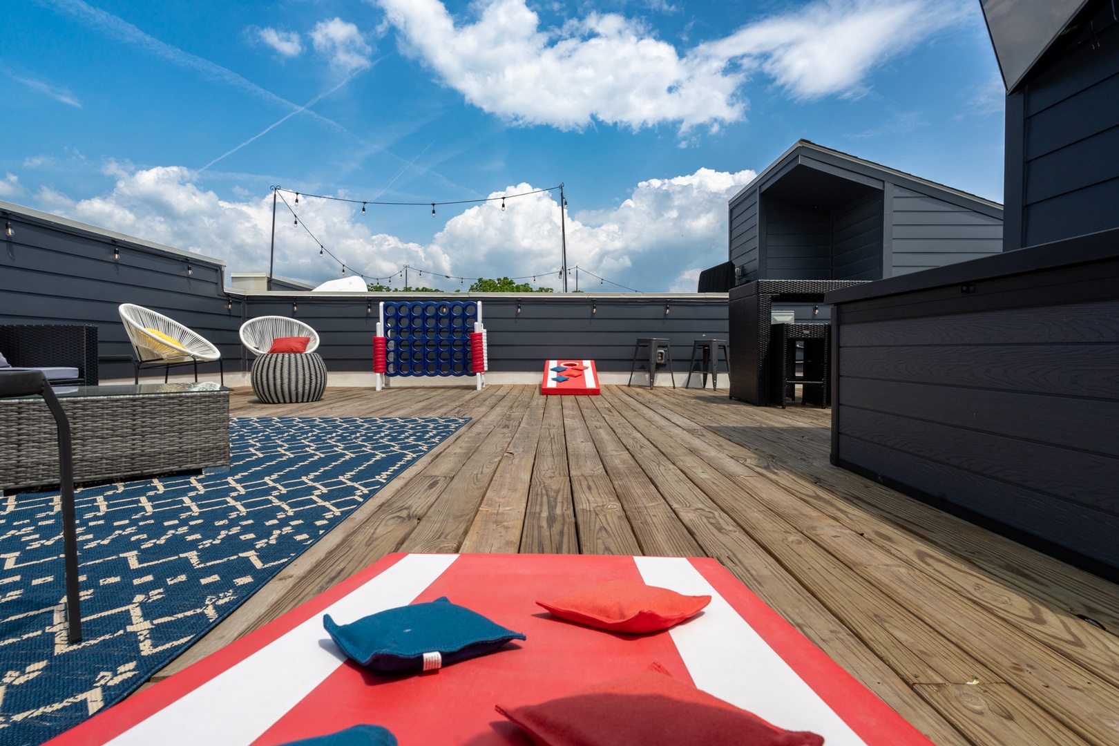 Rooftop deck with gas BBQ grill, cornhole, and ample seating