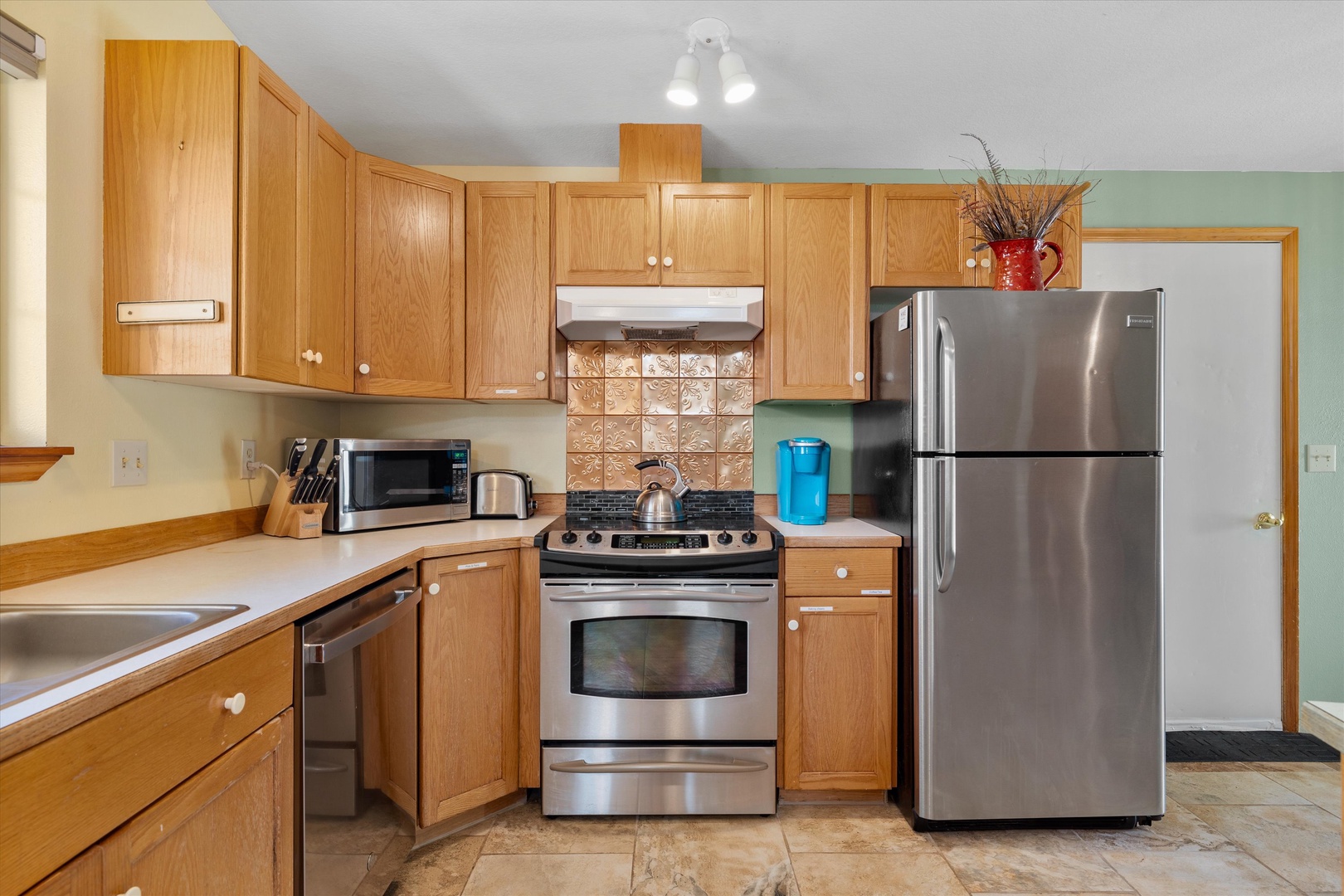 The open, breezy kitchen offers ample space & all the comforts of home