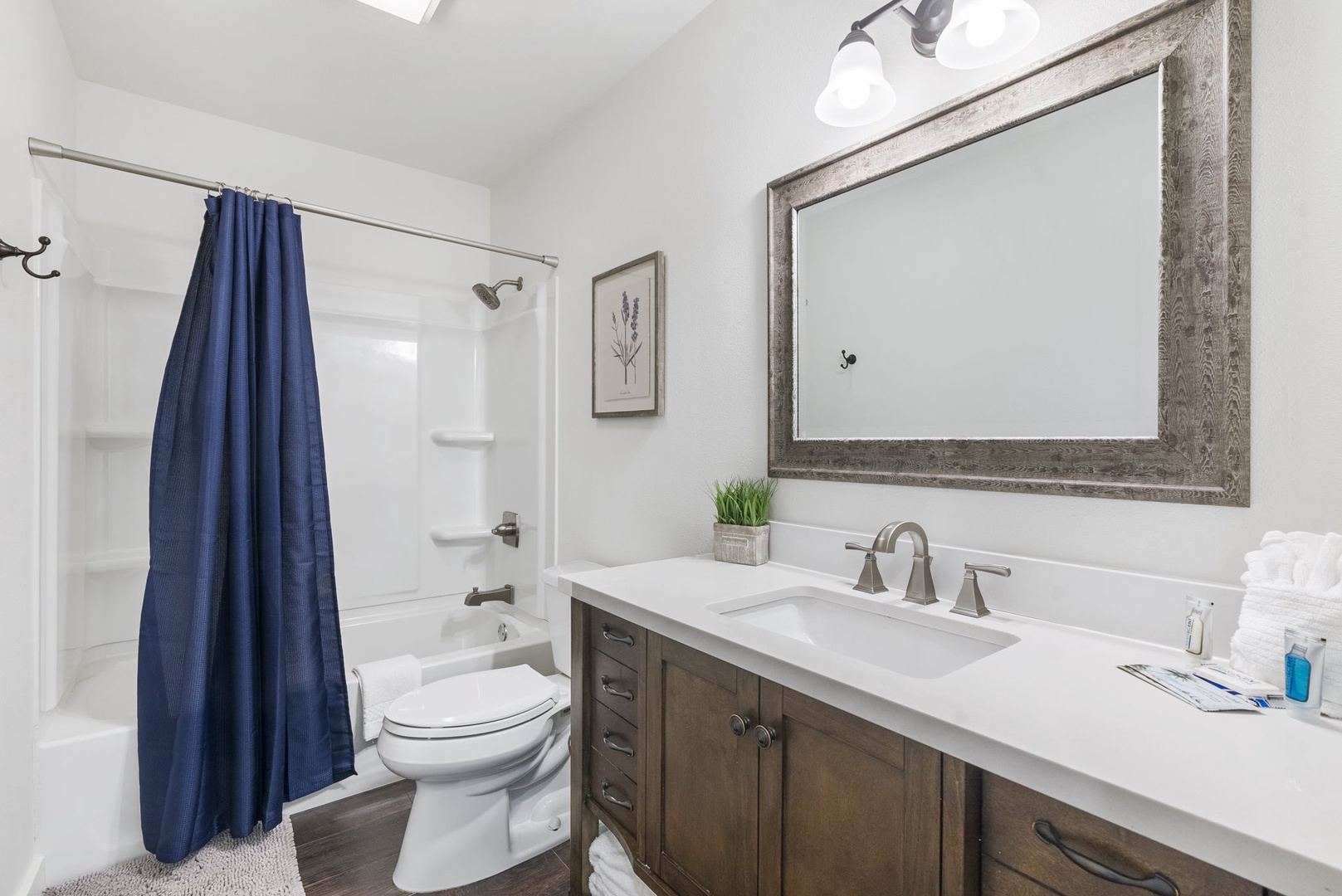 This full bathroom includes an oversized single vanity & shower/tub combo