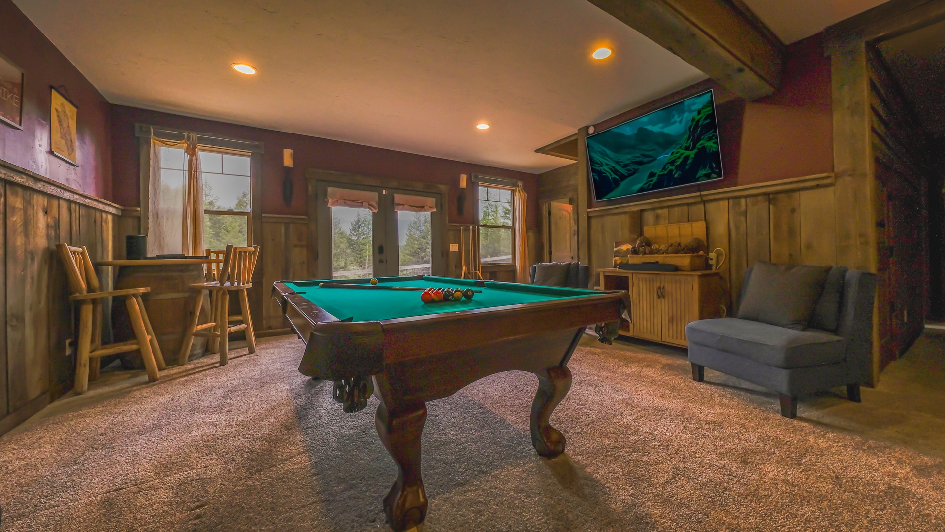 Fun and relaxation for everyone in the game room with pool table and TV