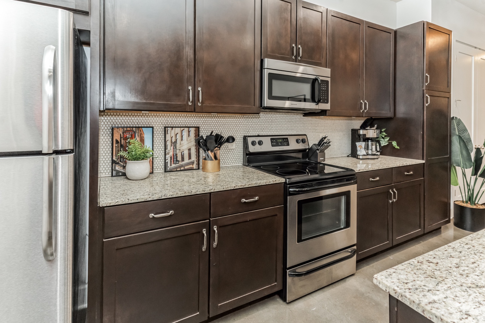 The chic, open kitchen offers ample space & all the comforts of home