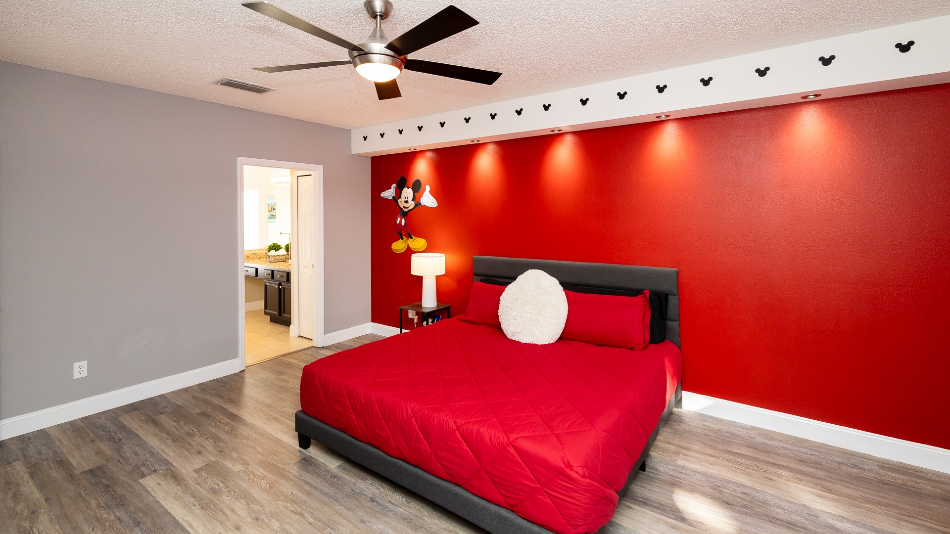 Mickey-themed bedroom with king bed, smart TV, and ensuite bath for a magical stay