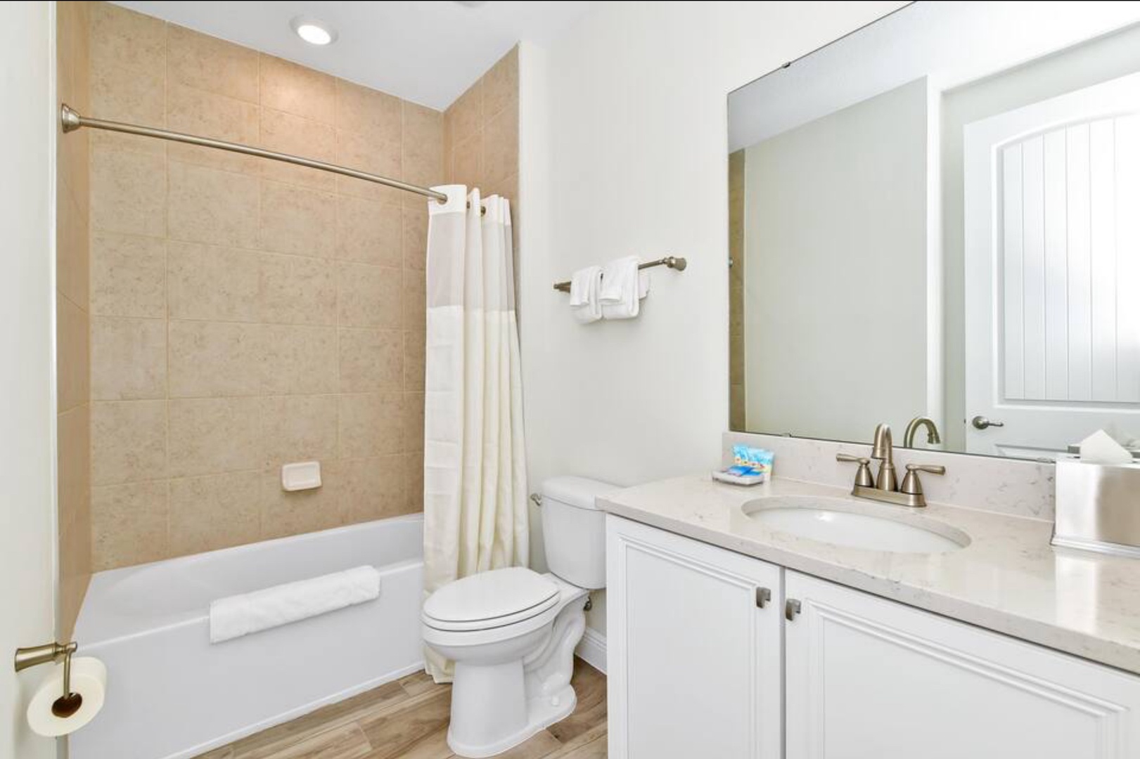 Shared bathroom with single vanity with shower/tub combo