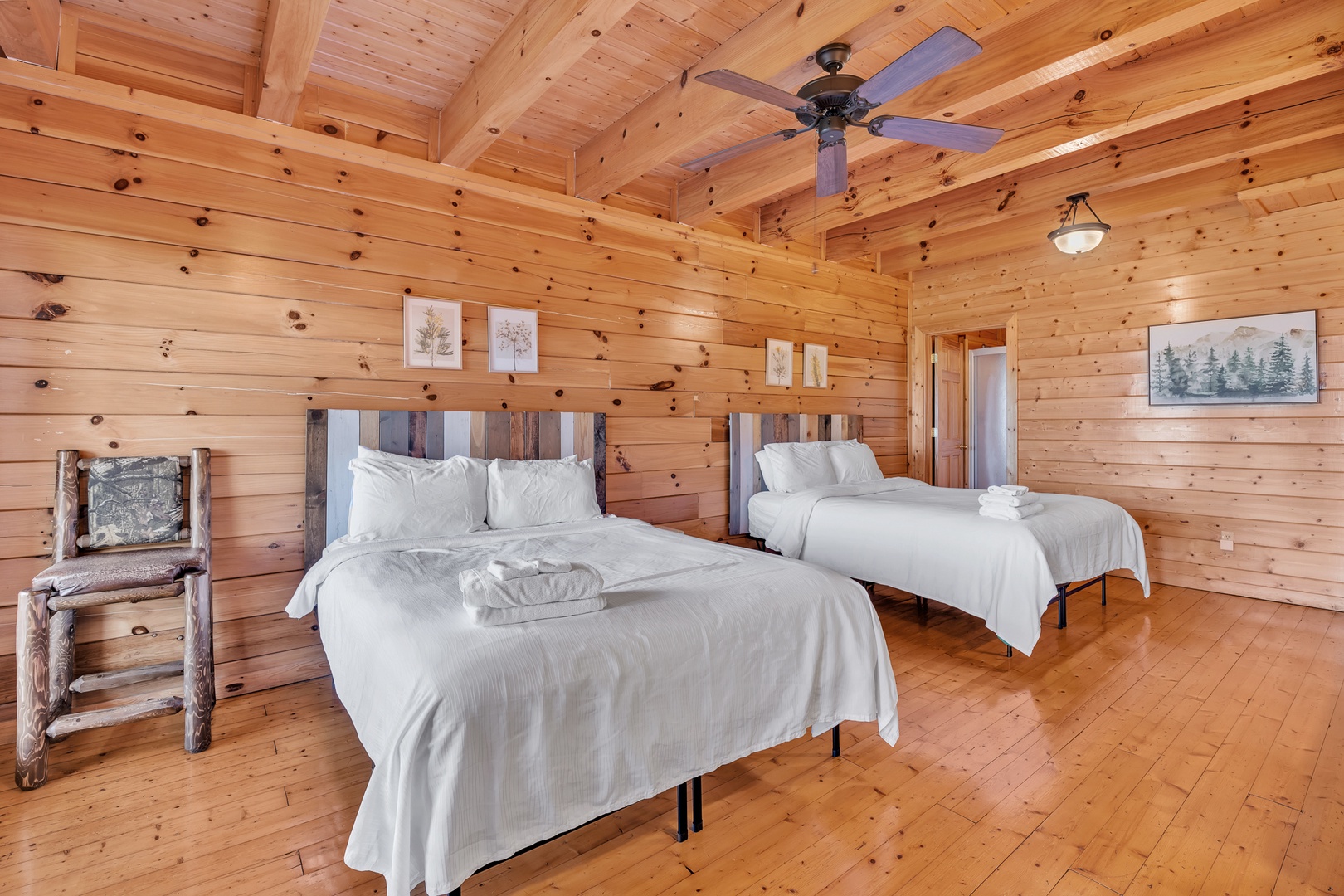 The 4th bedroom offers a pair of queen beds, private en suite, TV, & balcony