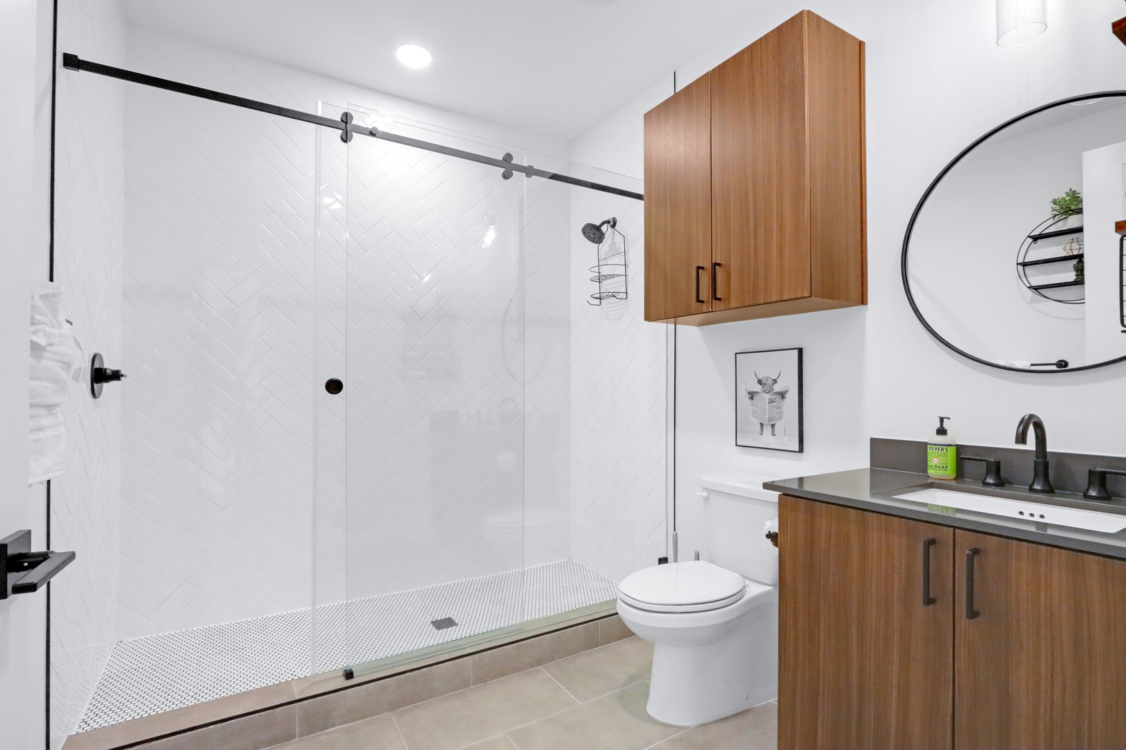 A single vanity & glass shower awaits in the full bathroom