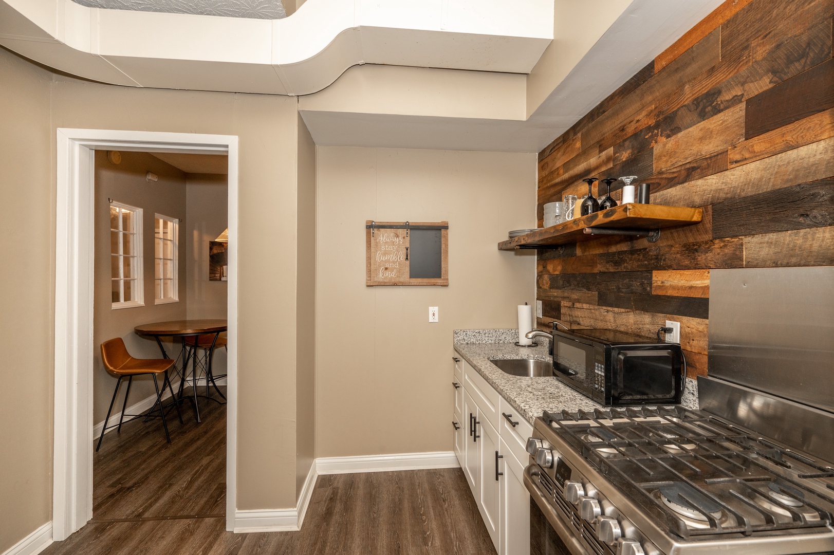 The kitchen is well-equipped for your visit & leads into a cozy dining area