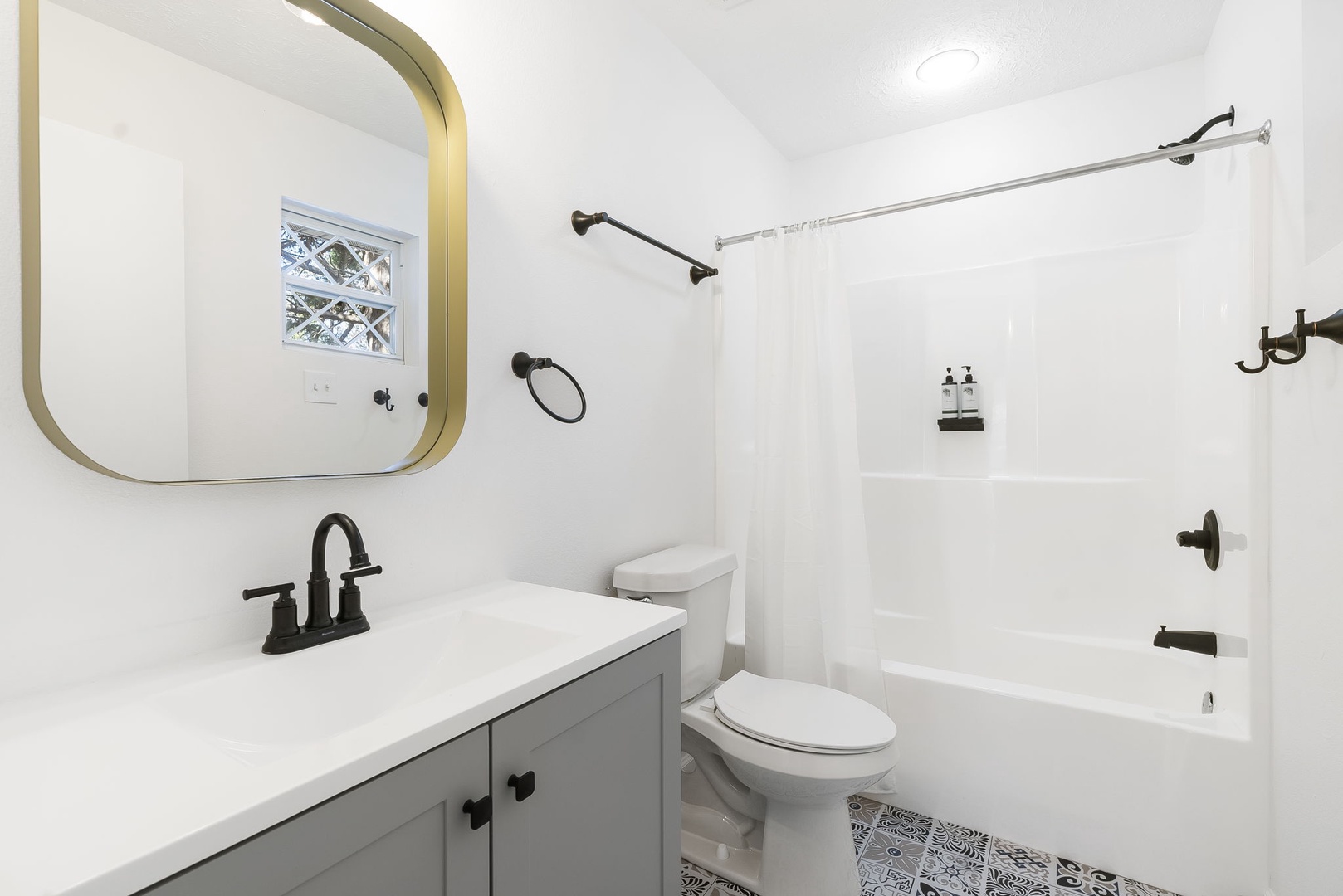The king en suite bath includes a single vanity & shower/tub combo
