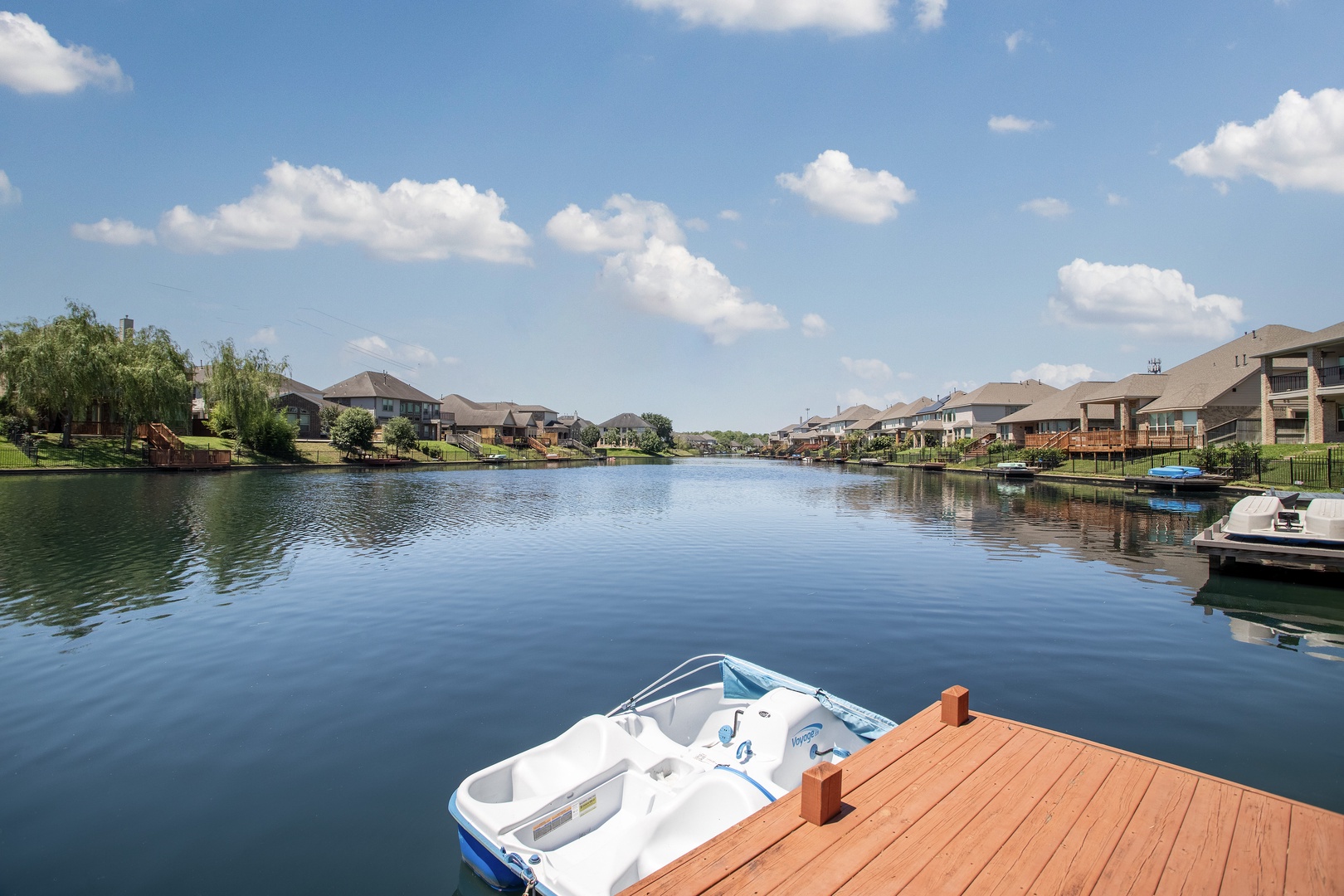 Unwind and enjoy serene lakeside views with your private dock, comfortable seating, and relaxing hot tub