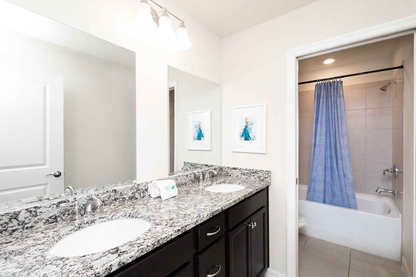 This 2nd floor hall bathroom includes a double vanity & shower/tub combo