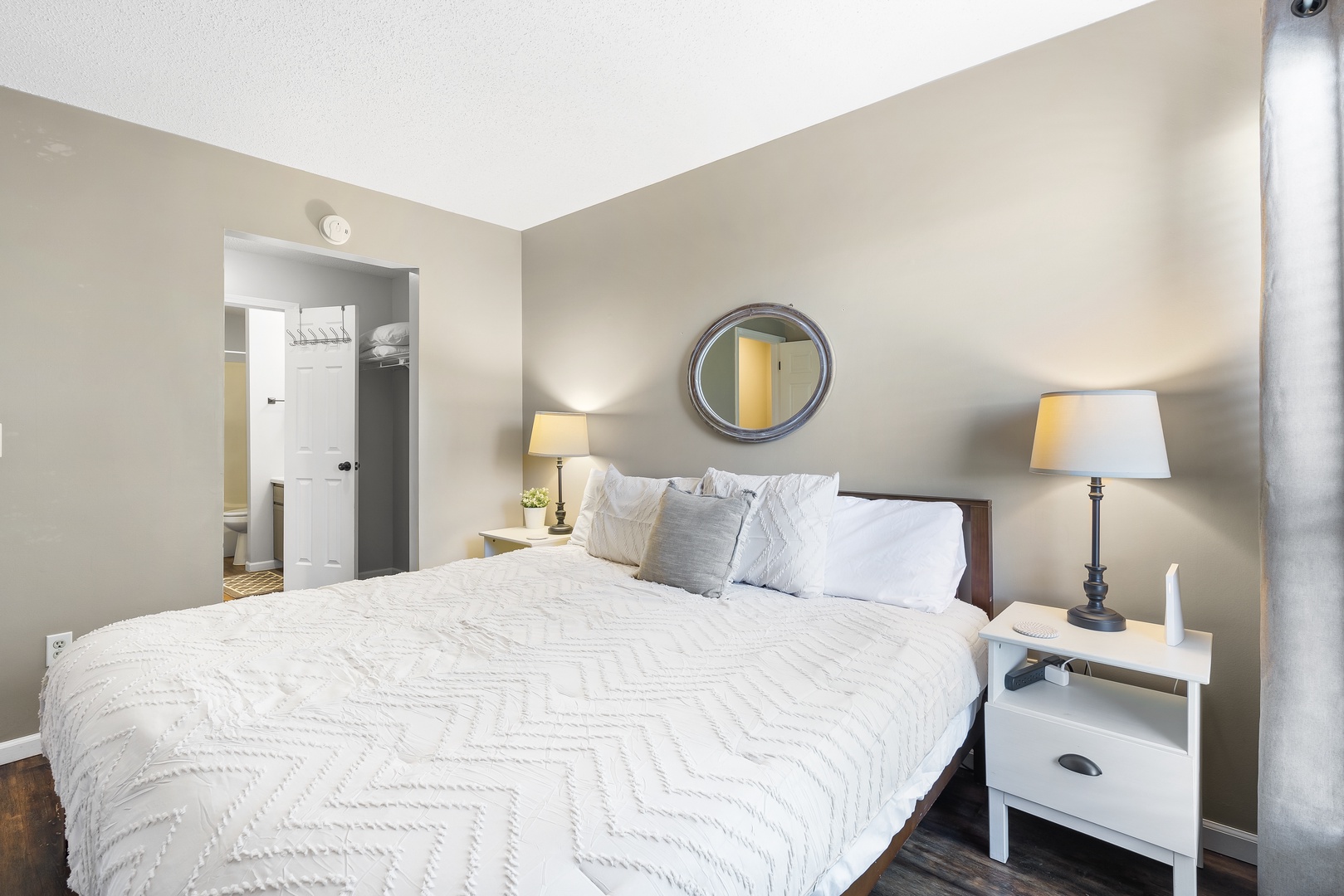 The master suite in Unit 20 boasts a plush king-sized bed, ensuite, & TV