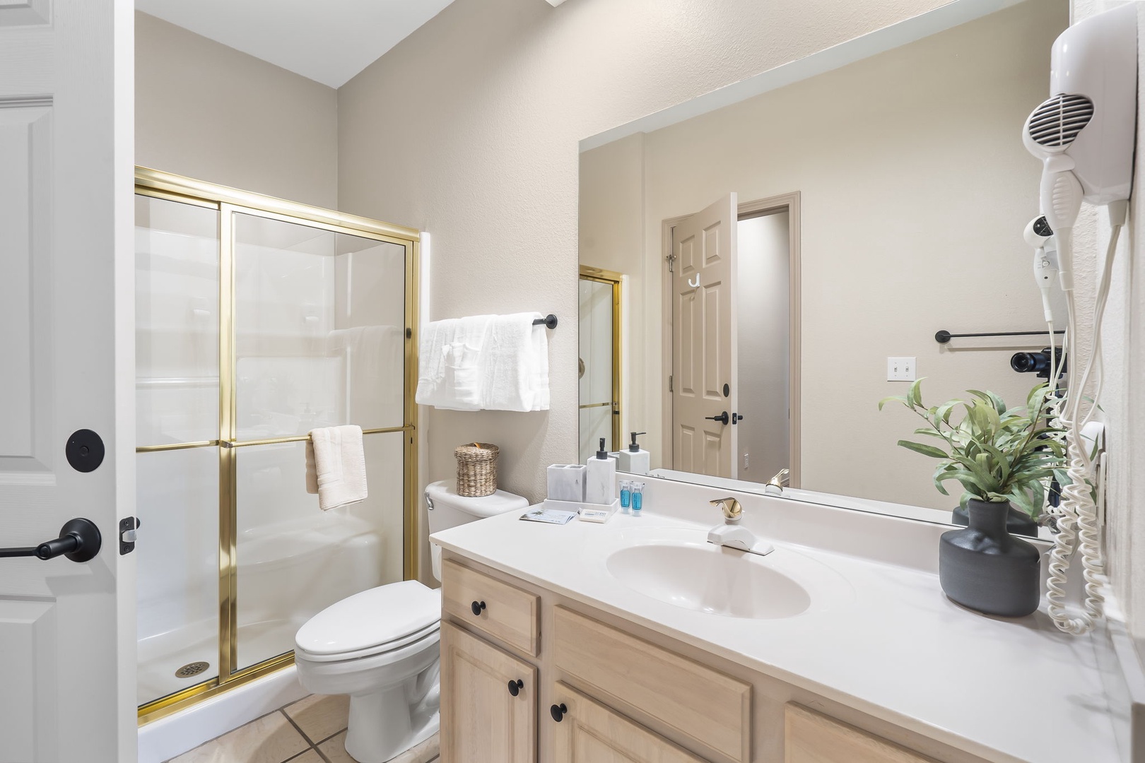 The queen bedroom en suite offers an oversized single vanity & glass shower