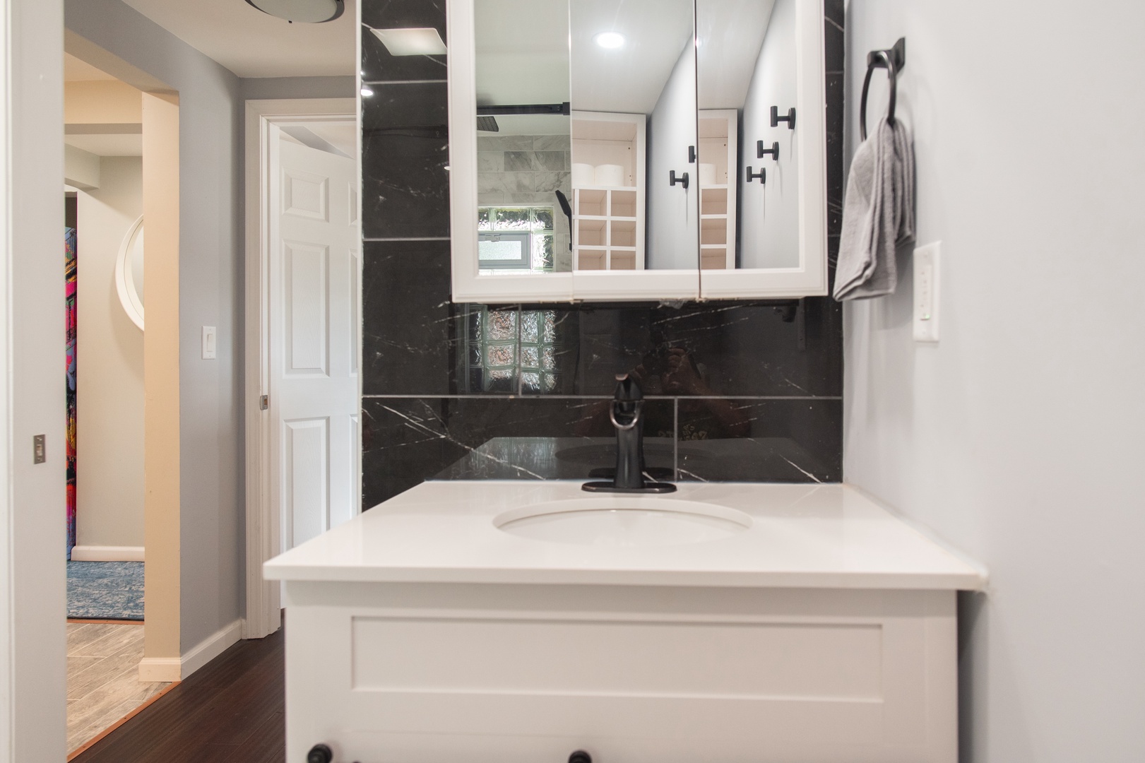 The full bathroom offers a single vanity & glass shower