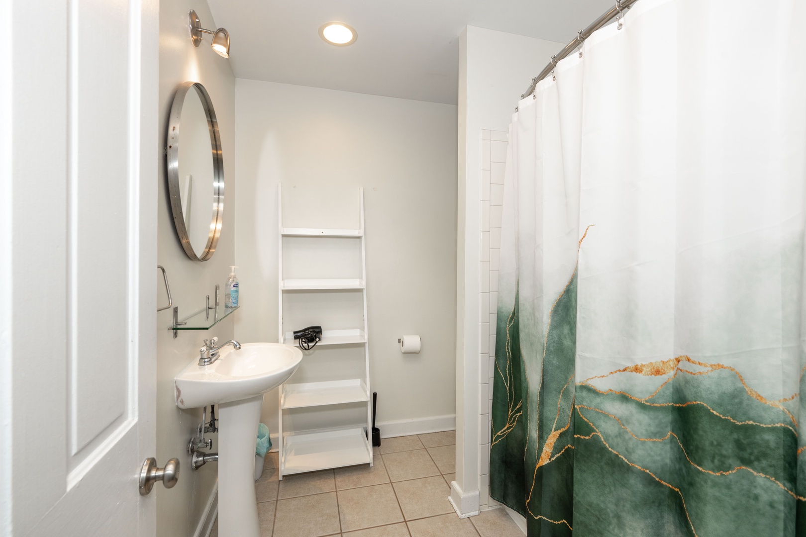The upper-level full bath includes a pedestal sink & shower/tub combo