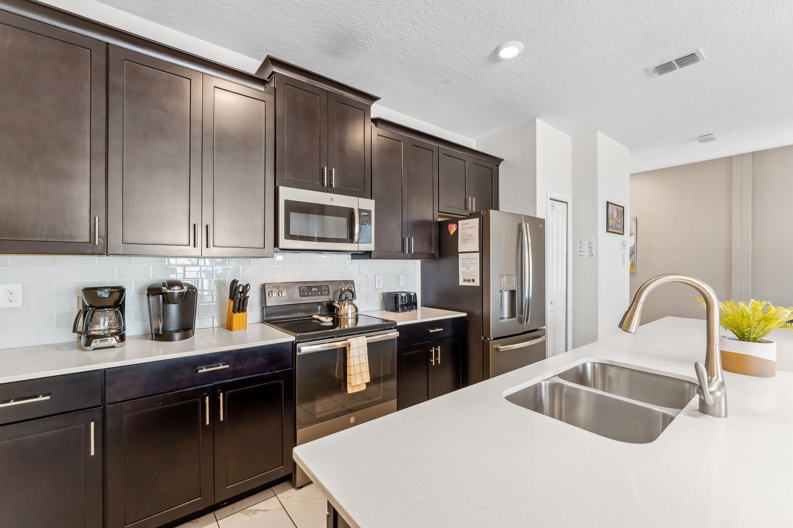 The open, airy kitchen offers ample space & all the comforts of home