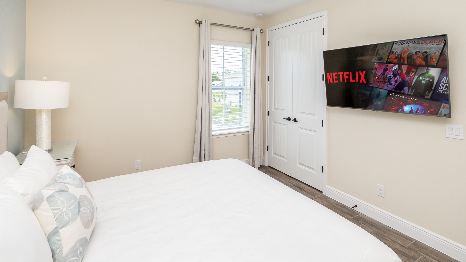 The king bedroom offers a ceiling fan, Smart TV, & plenty of space to unwind