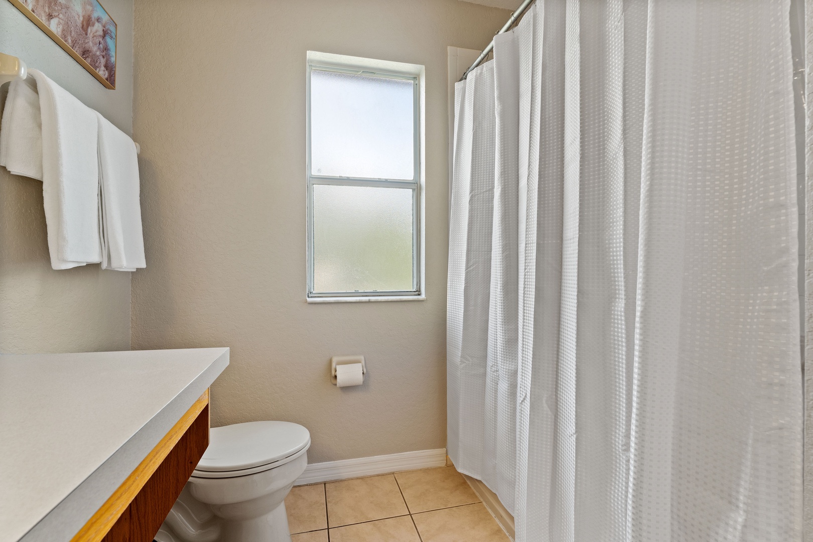 The king en suite offers a single vanity & shower/tub combo