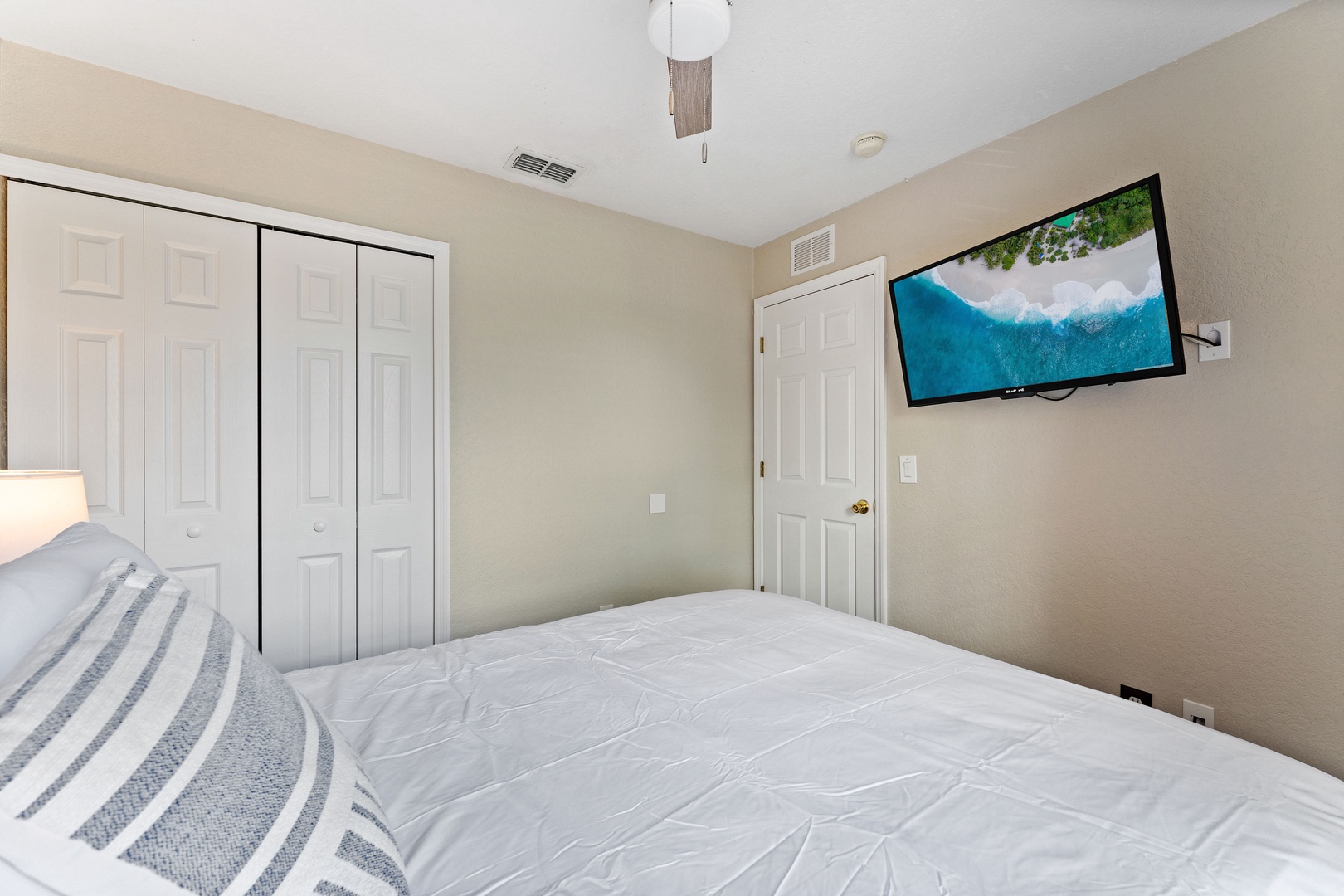 This 2nd floor queen bedroom includes a TV & ceiling fan