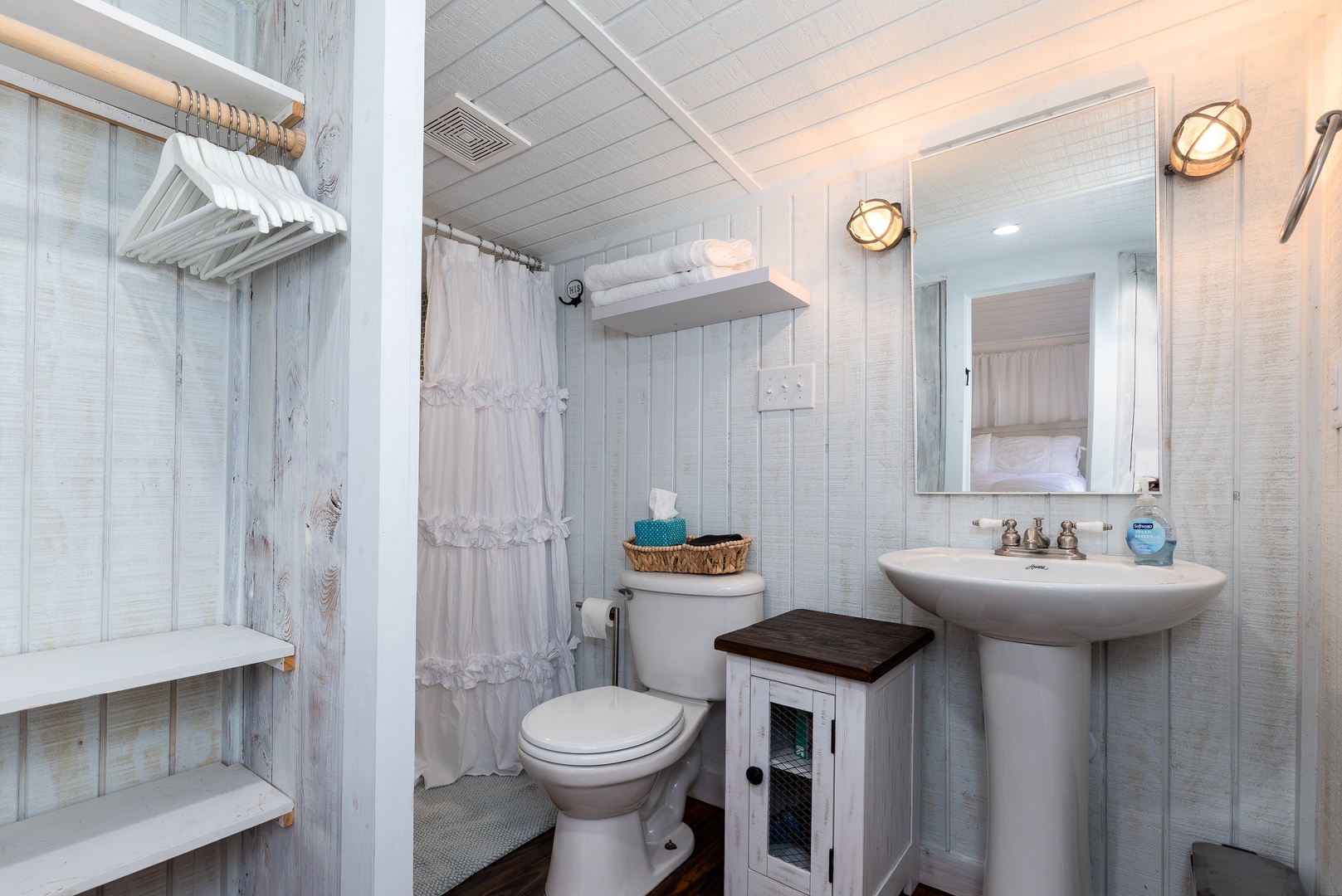 The full bathroom offers closet space, a single vanity & walk-in shower