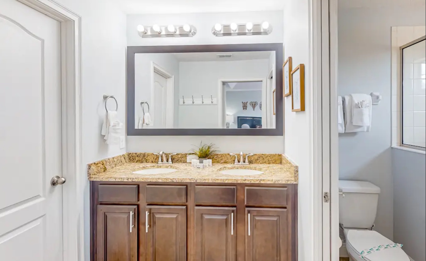 This ensuite full bath includes a dual vanity & glass shower