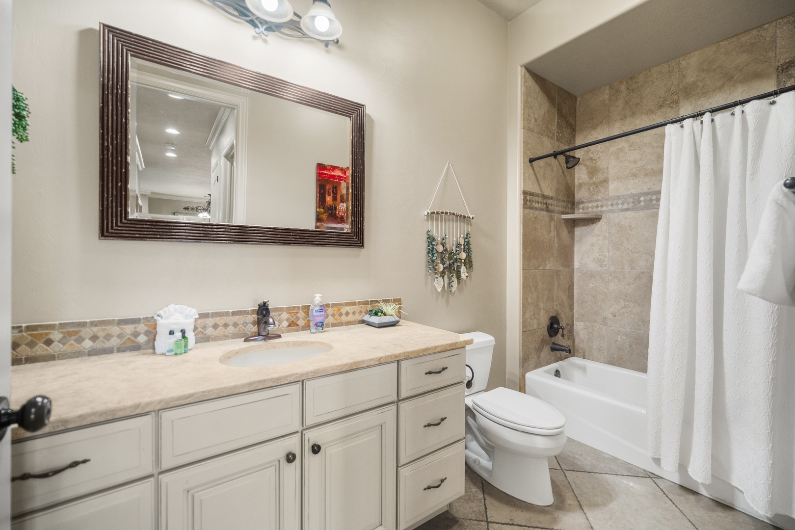 The shared main floor full bath includes a single vanity & shower/tub combo