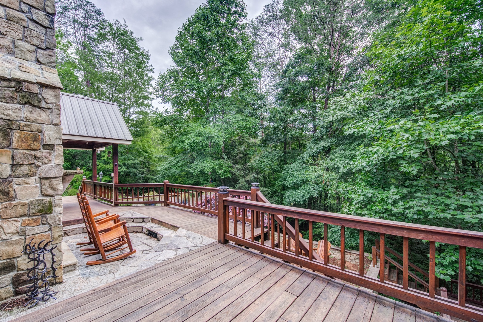 Enjoy the outdoor fireplace and rocking chairs on the deck