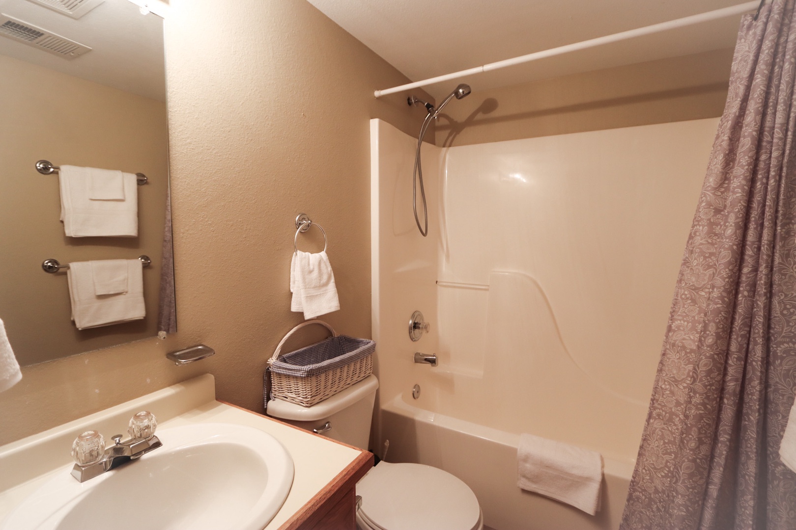The shared full bathroom offers a single vanity & shower/tub combo