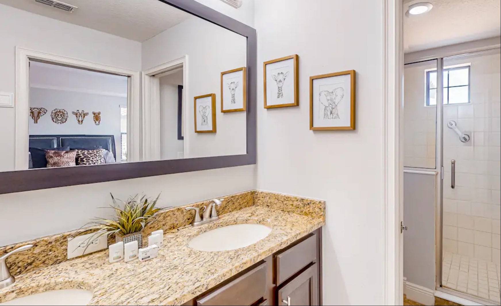 This ensuite full bath includes a dual vanity & glass shower