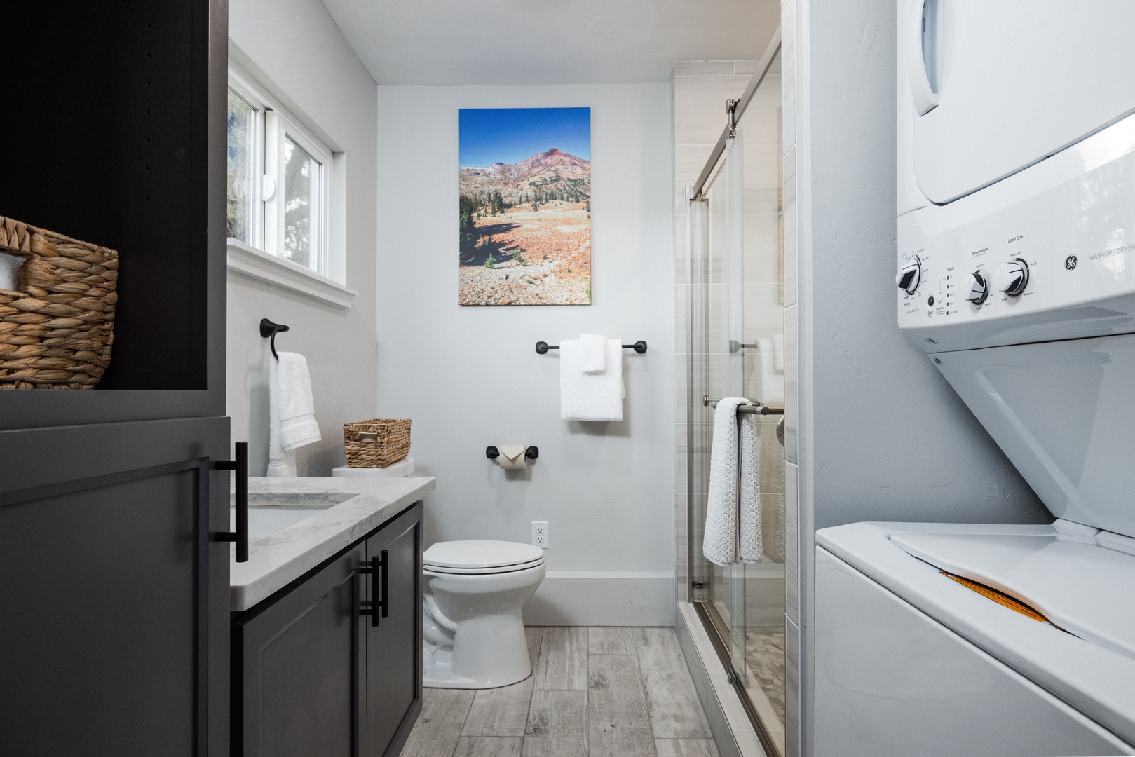 Full bathroom with stand-up shower and laundry
