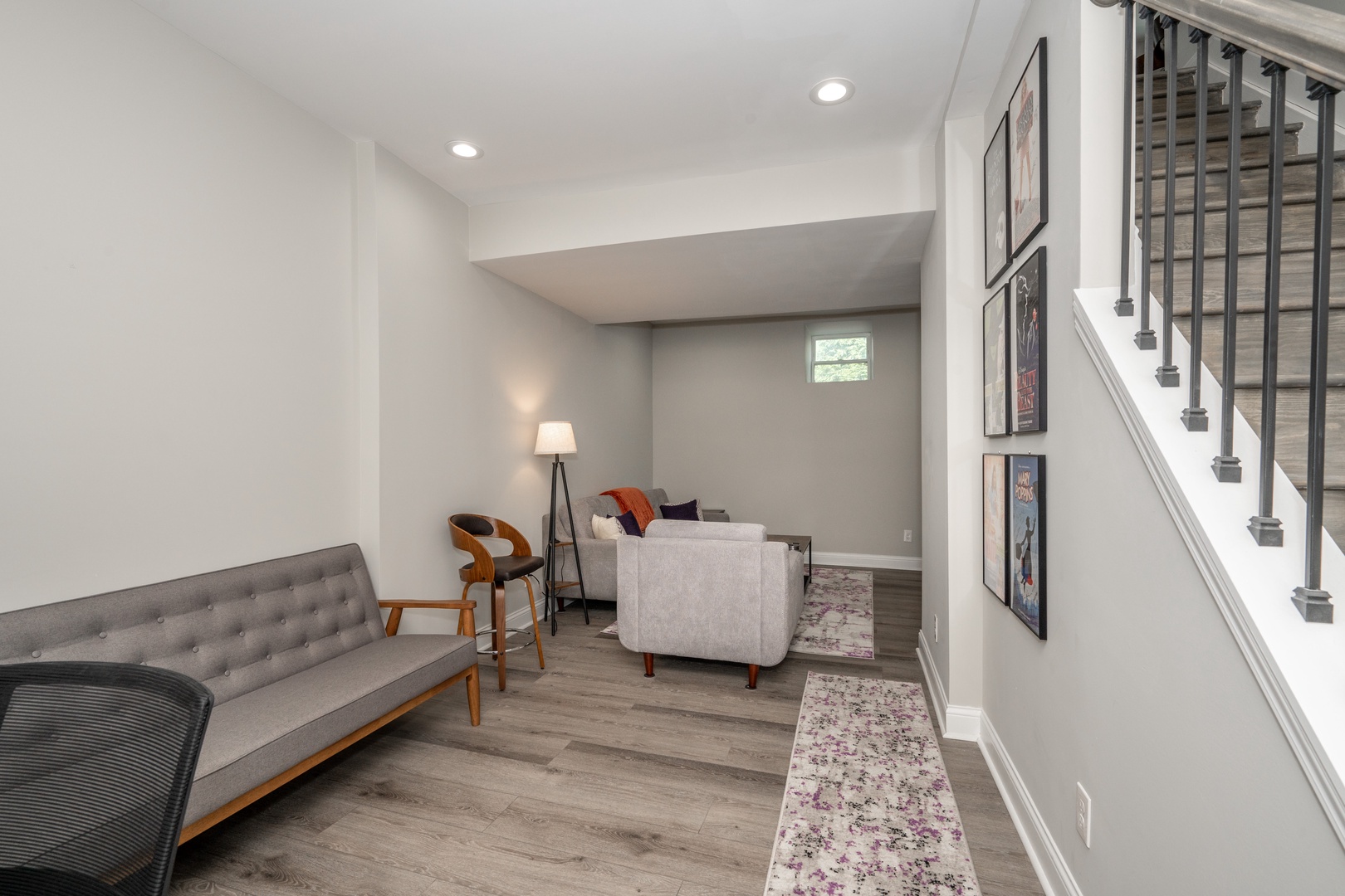 Basement with sofa, TV, and work/study table