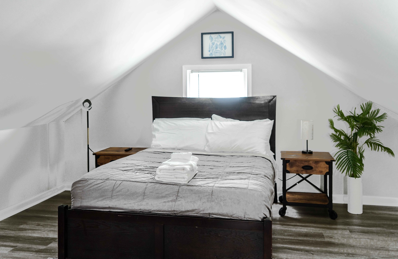 The serene 2nd-floor bedroom boasts a pair of full-sized beds & smart TV