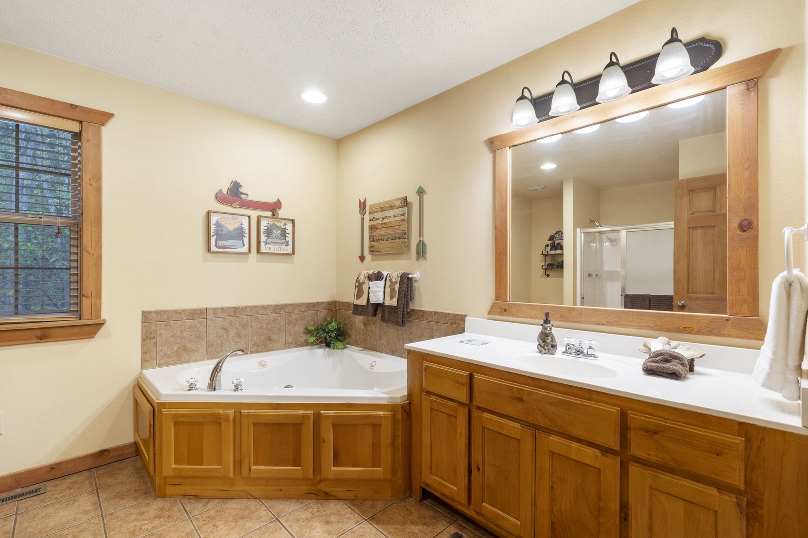 This king ensuite includes a large vanity, glass shower, & luxurious jetted tub