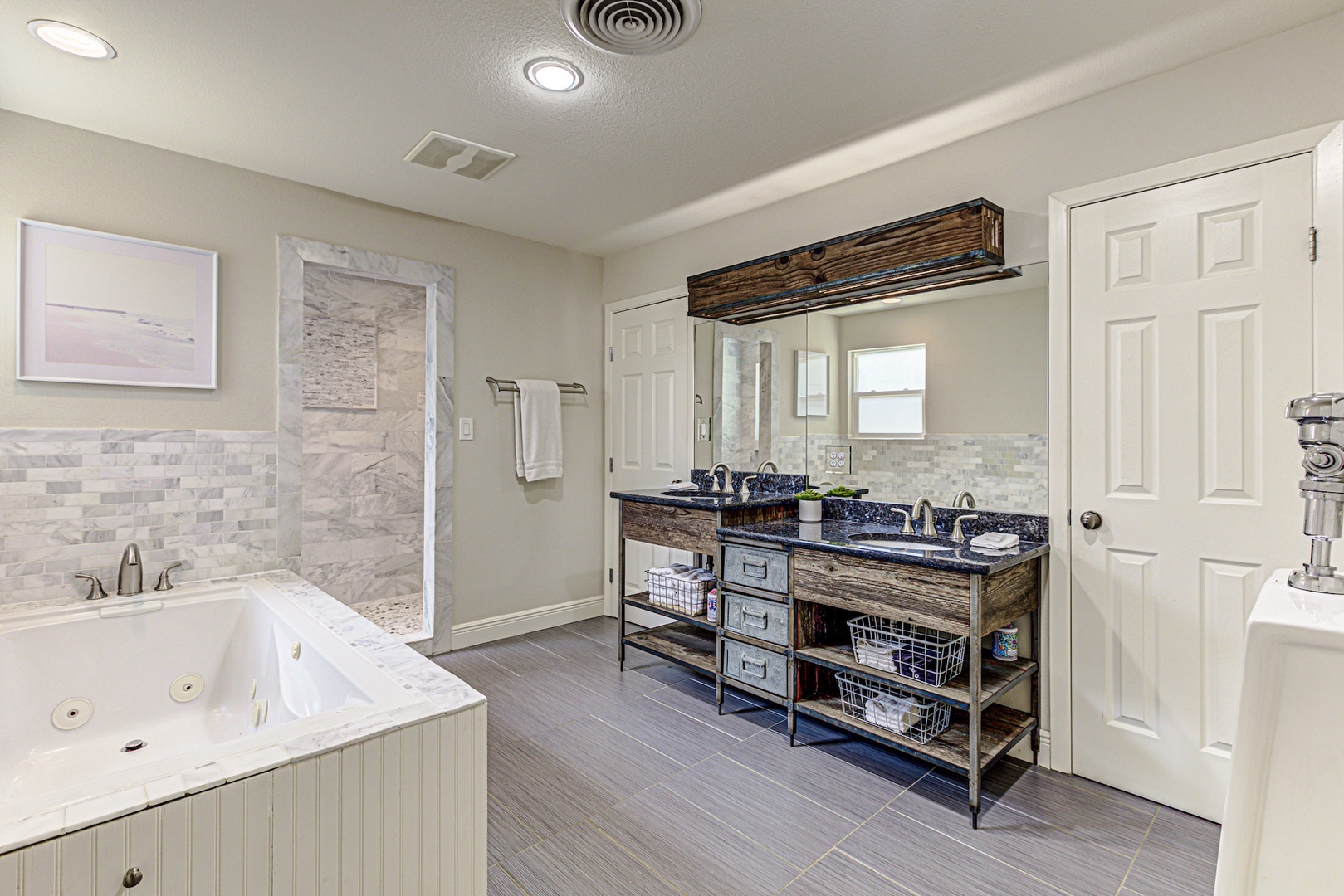 Enjoy a double vanity, soaking tub, & walk-in shower in the king ensuite