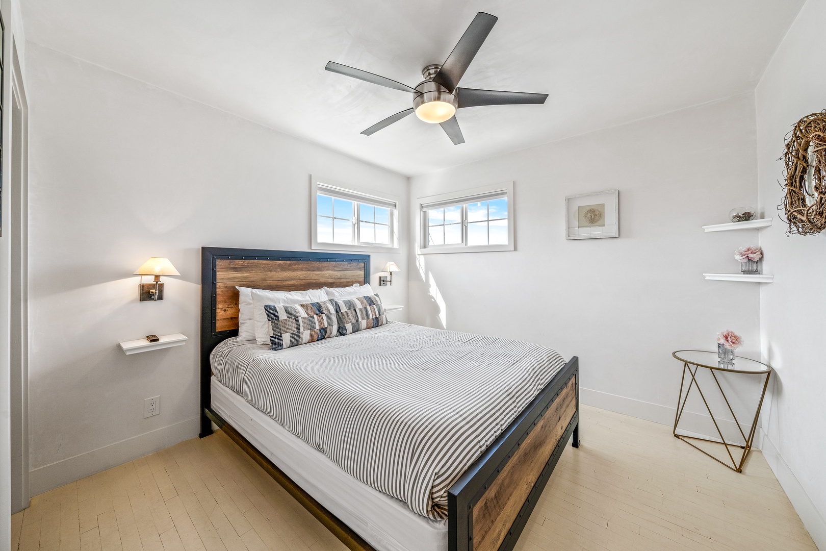 The first of two spacious bedrooms offers a king bed & ceiling fan