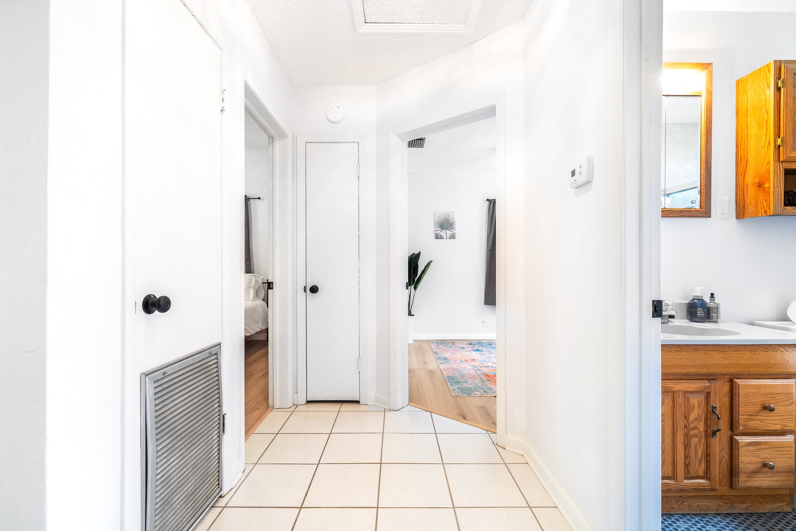 A single vanity & shower/tub combo await in the first hall bath