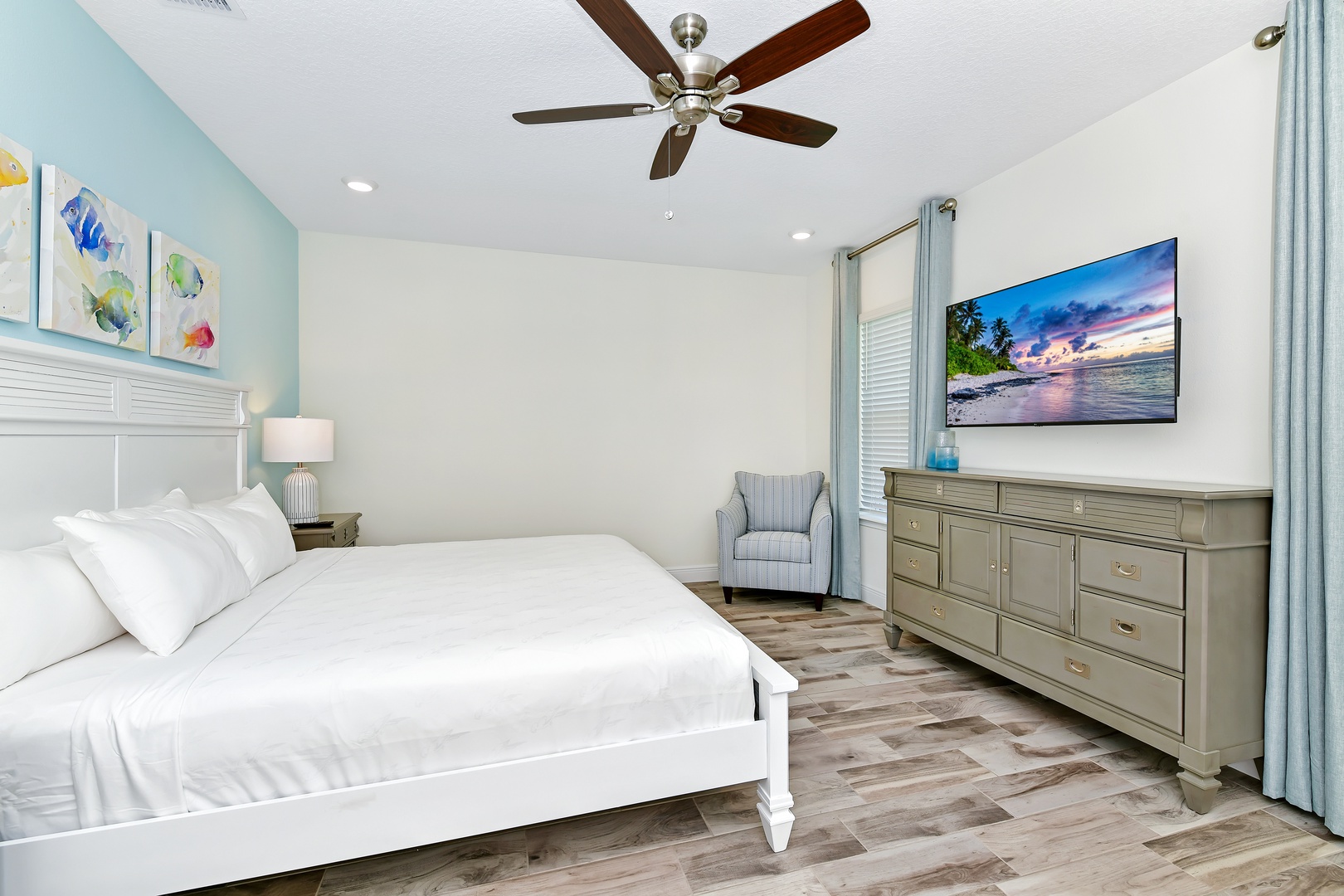 2nd Floor Master featuring a cozy king bed, ceiling fan and private ensuite