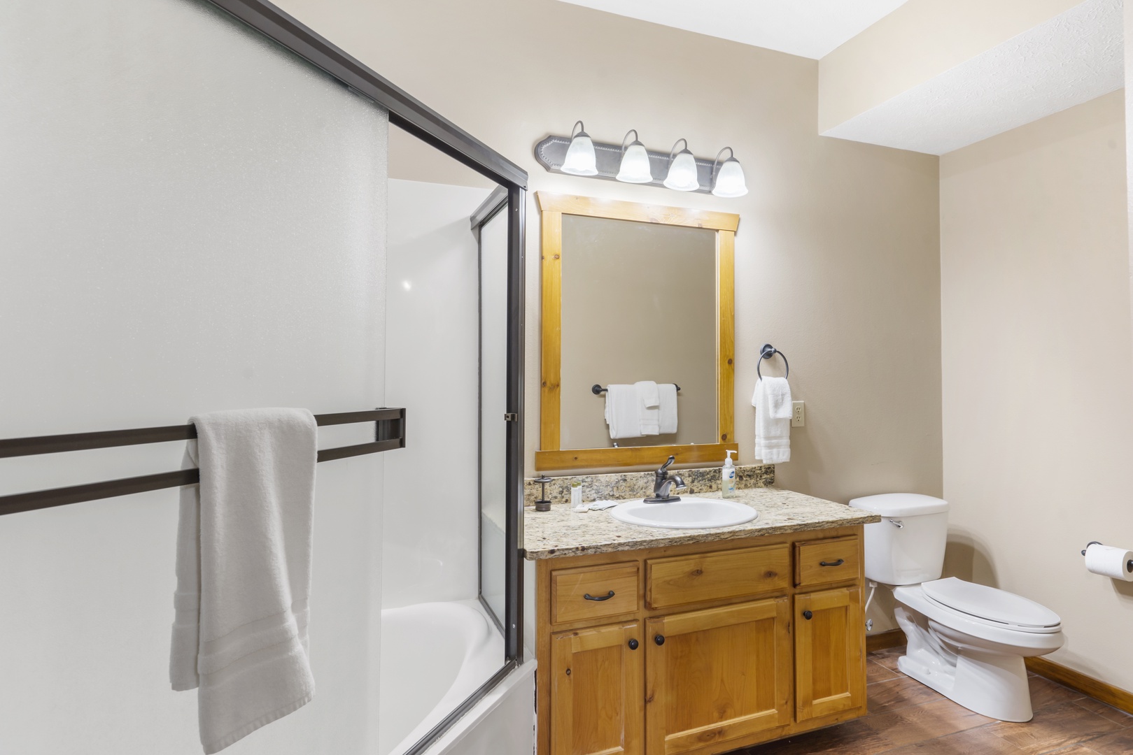 The first lower-level ensuite includes a single vanity & shower/tub combo