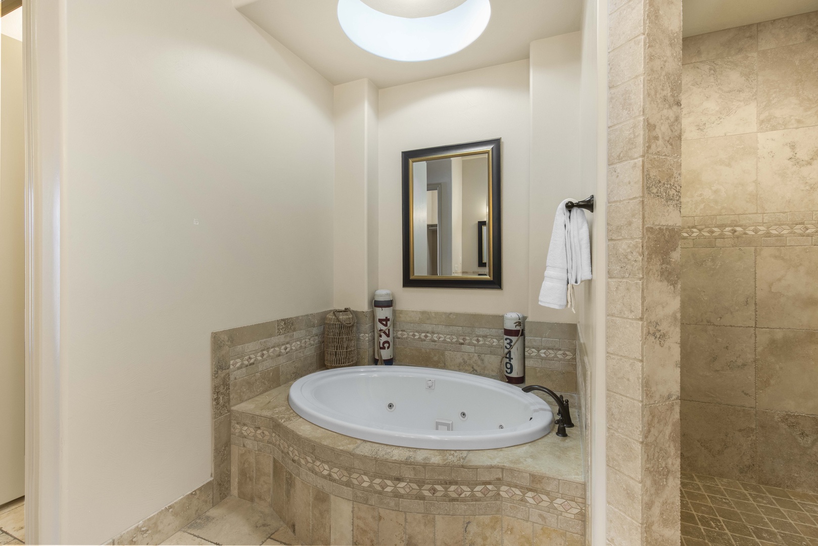 The king en suite bath boasts a double vanity, shower, & Jacuzzi soaking tub